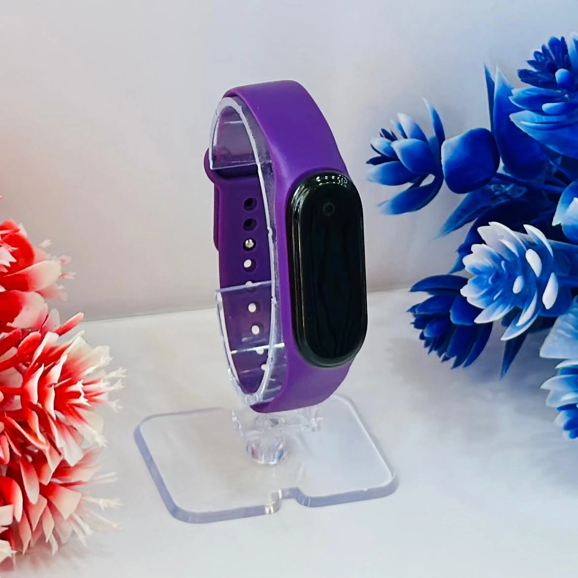 appears to be an Aquarius AQ112 fitness tracker in purple.