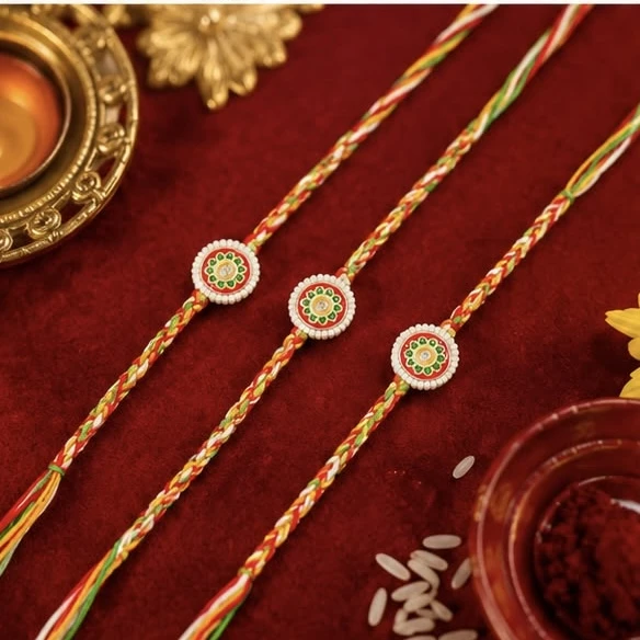 Meenakari Rakhis, featuring a set of three traditional multicolor threads.