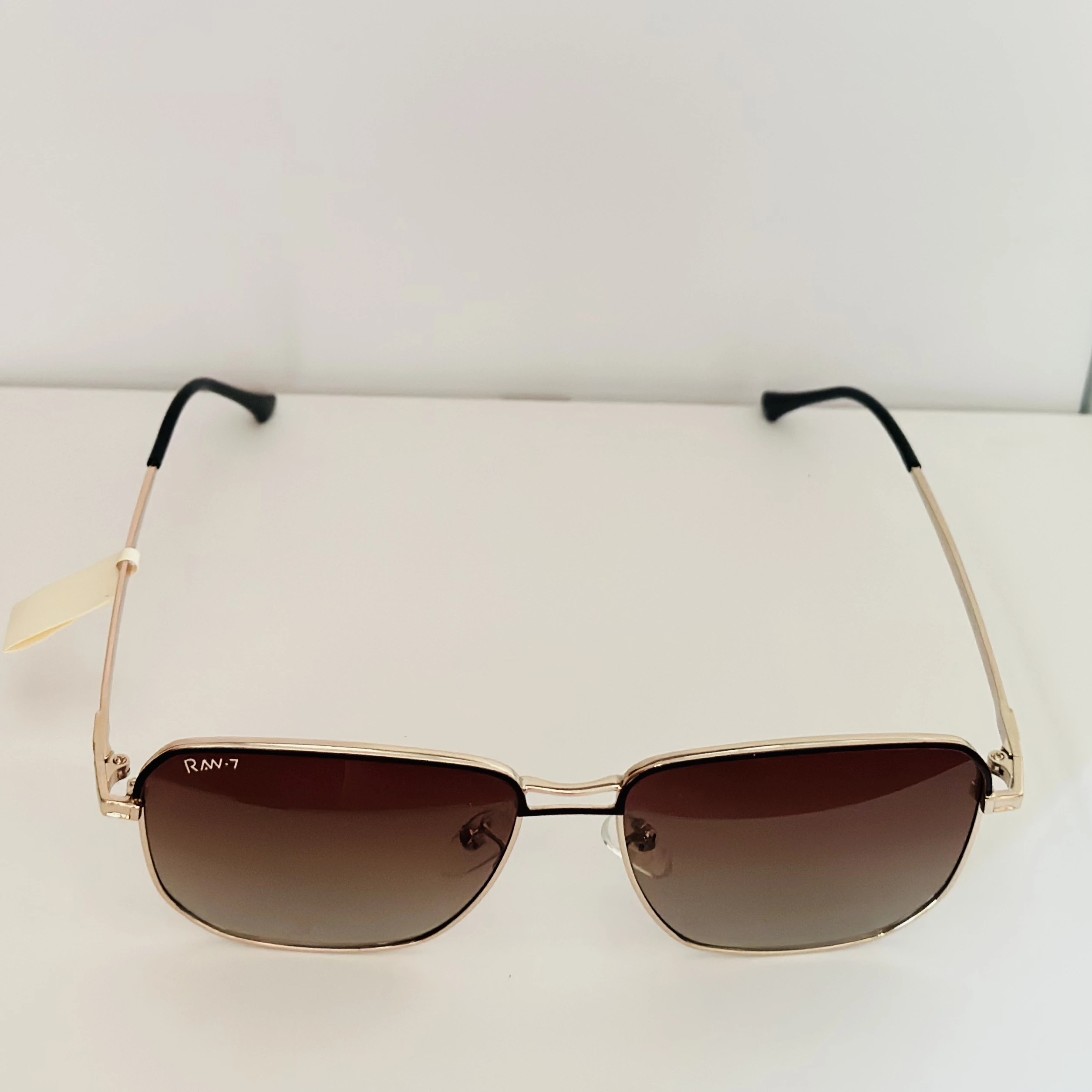 Victoria Beckham VB207S sunglasses in gold with brown gradient lenses.