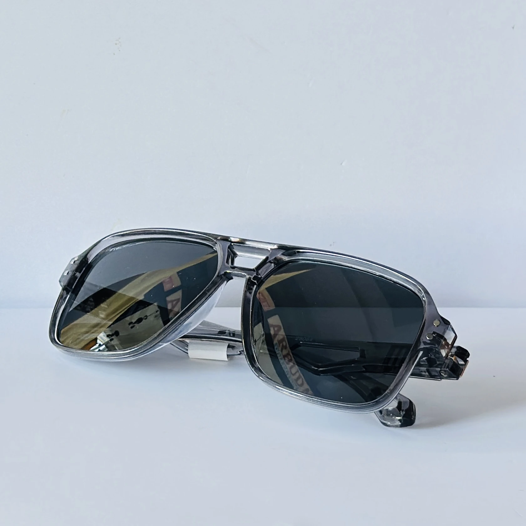 sunglasses in a transparent grey frame color.