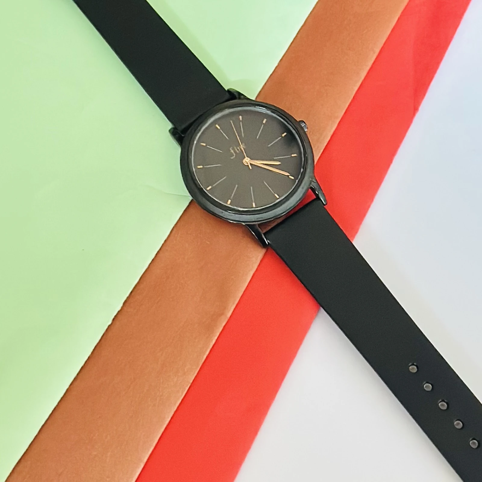 women's analog watch in black with a silicone strap.