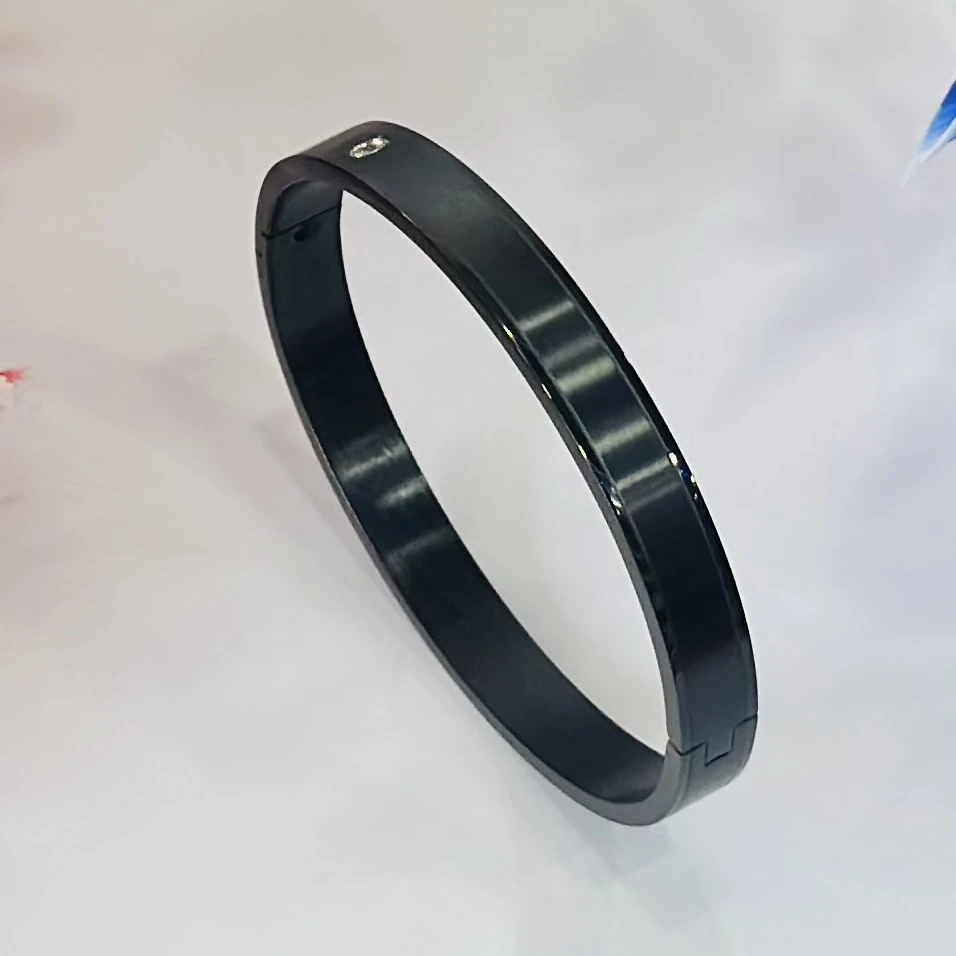 Black stainless steel kada bracelet with a diamond accent.