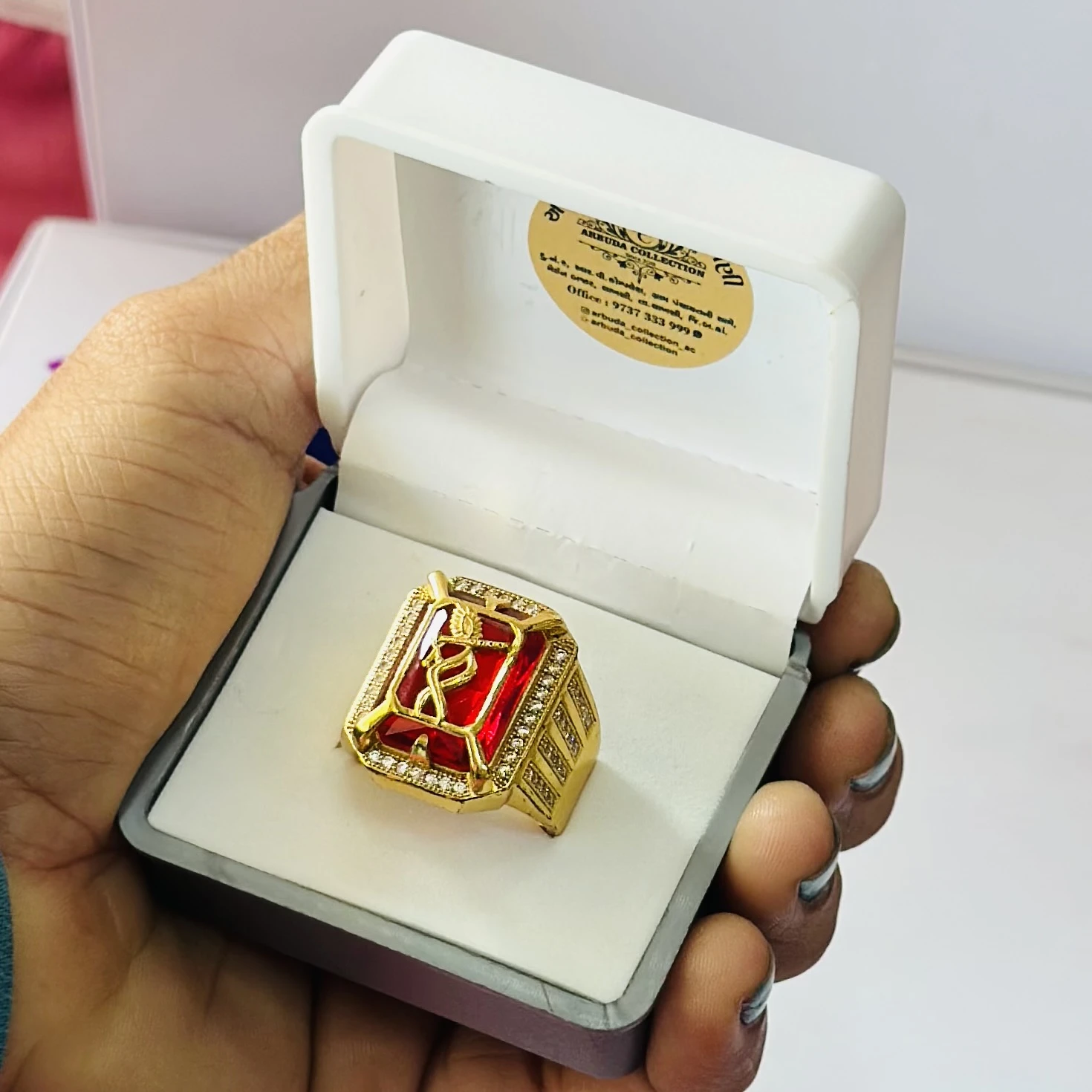 1 gram gold-plated Mudra ring with a red stone centerpiece.
