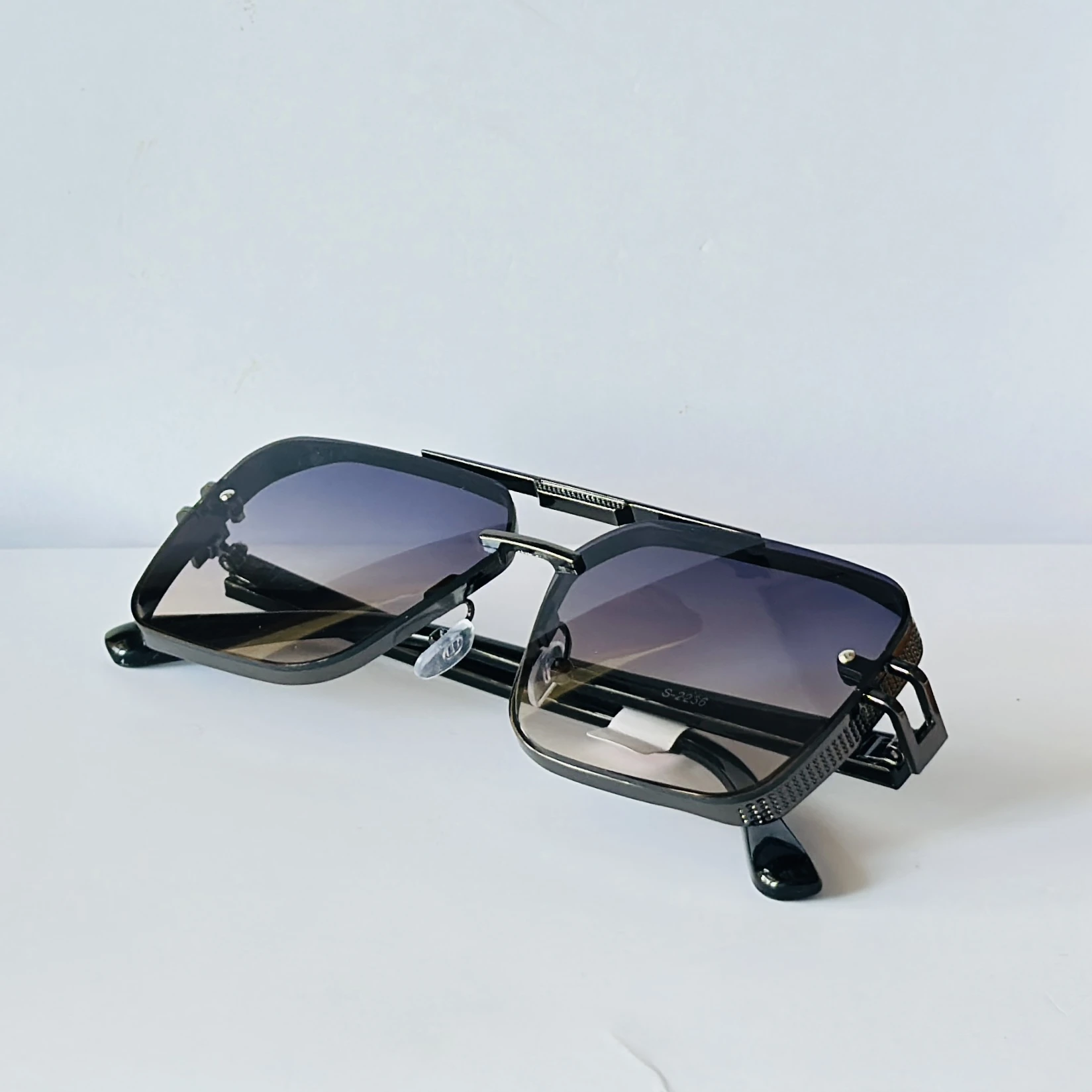appear to be retro square or modern pilot-style sunglasses for men