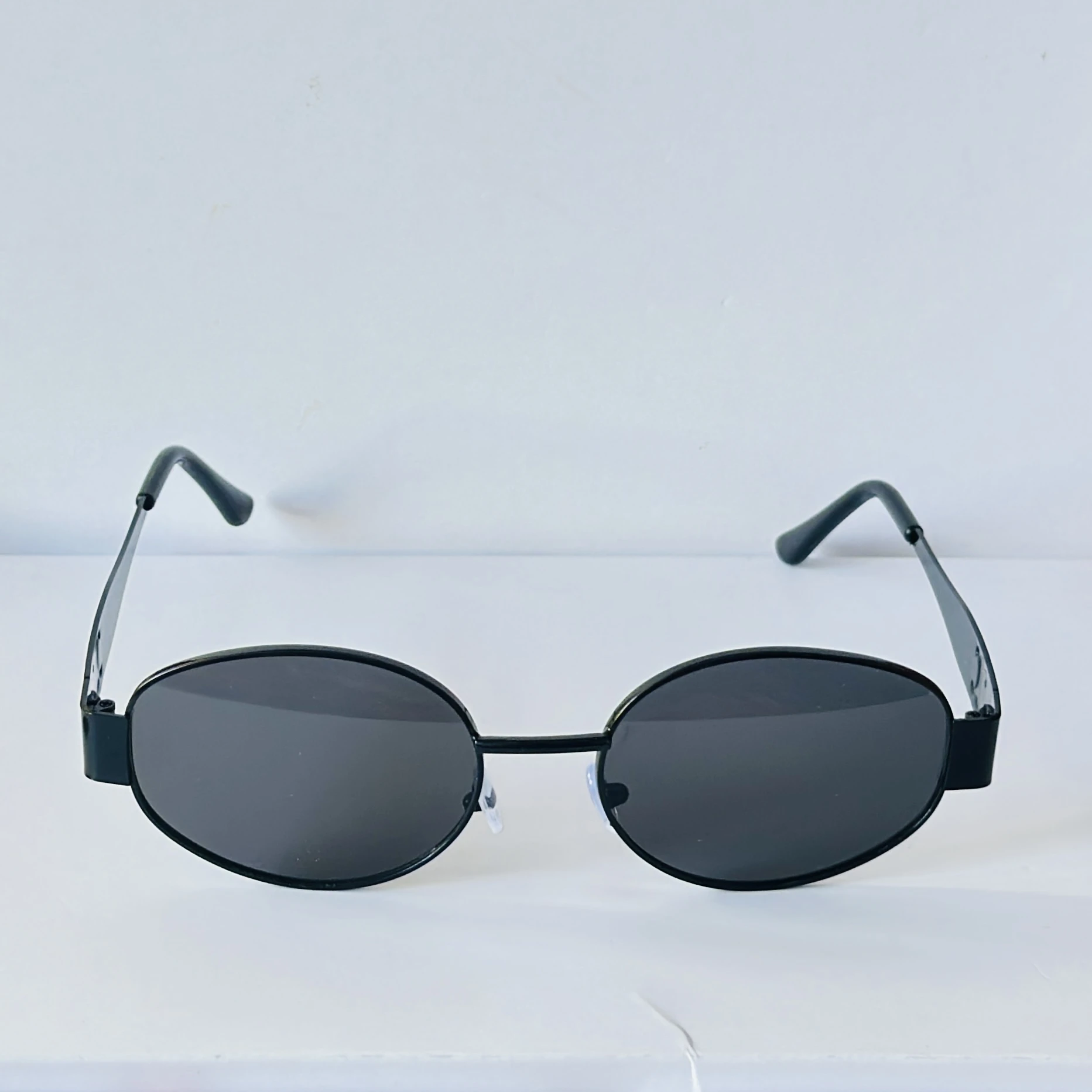 Black sunglasses feature a metal frame and black lenses