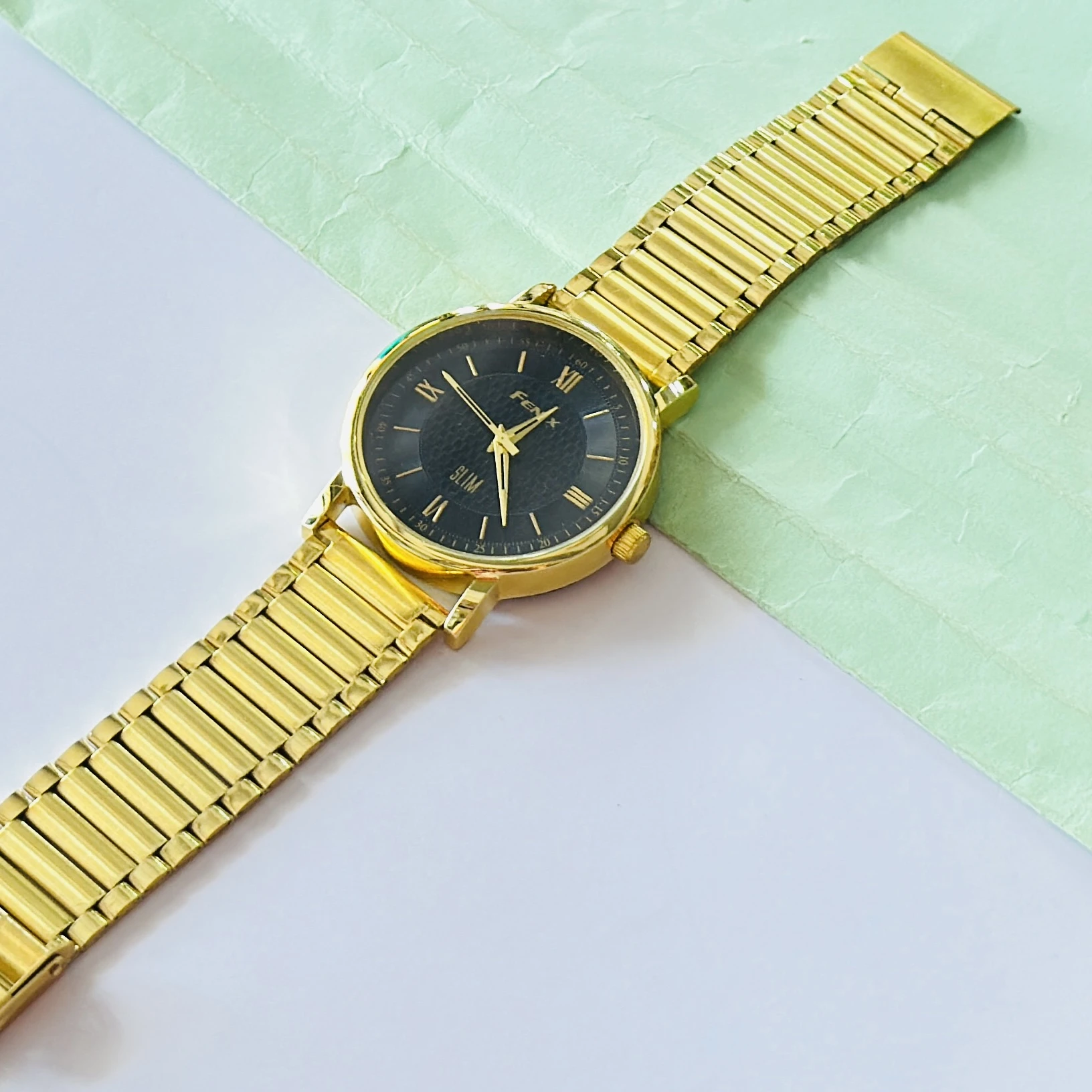Gold coloured analogue watch