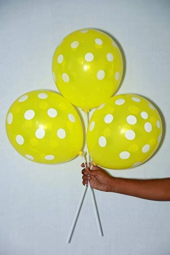 package of Yellow party balloons with white polka dots.