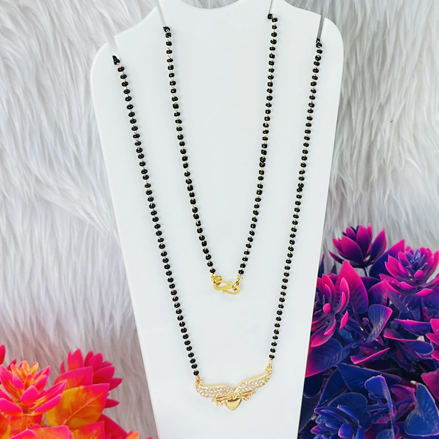 Gold plated mangalsutra with a cubic zirconia pendant.