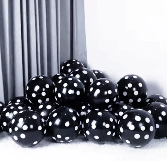 package of black party balloons with white polka dots.