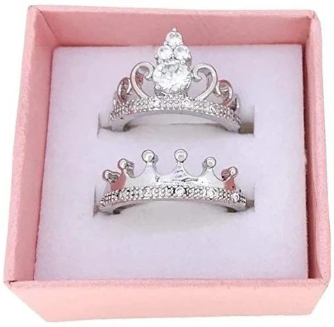 Silver plated, cubic zirconia-studded crown couple rings.
