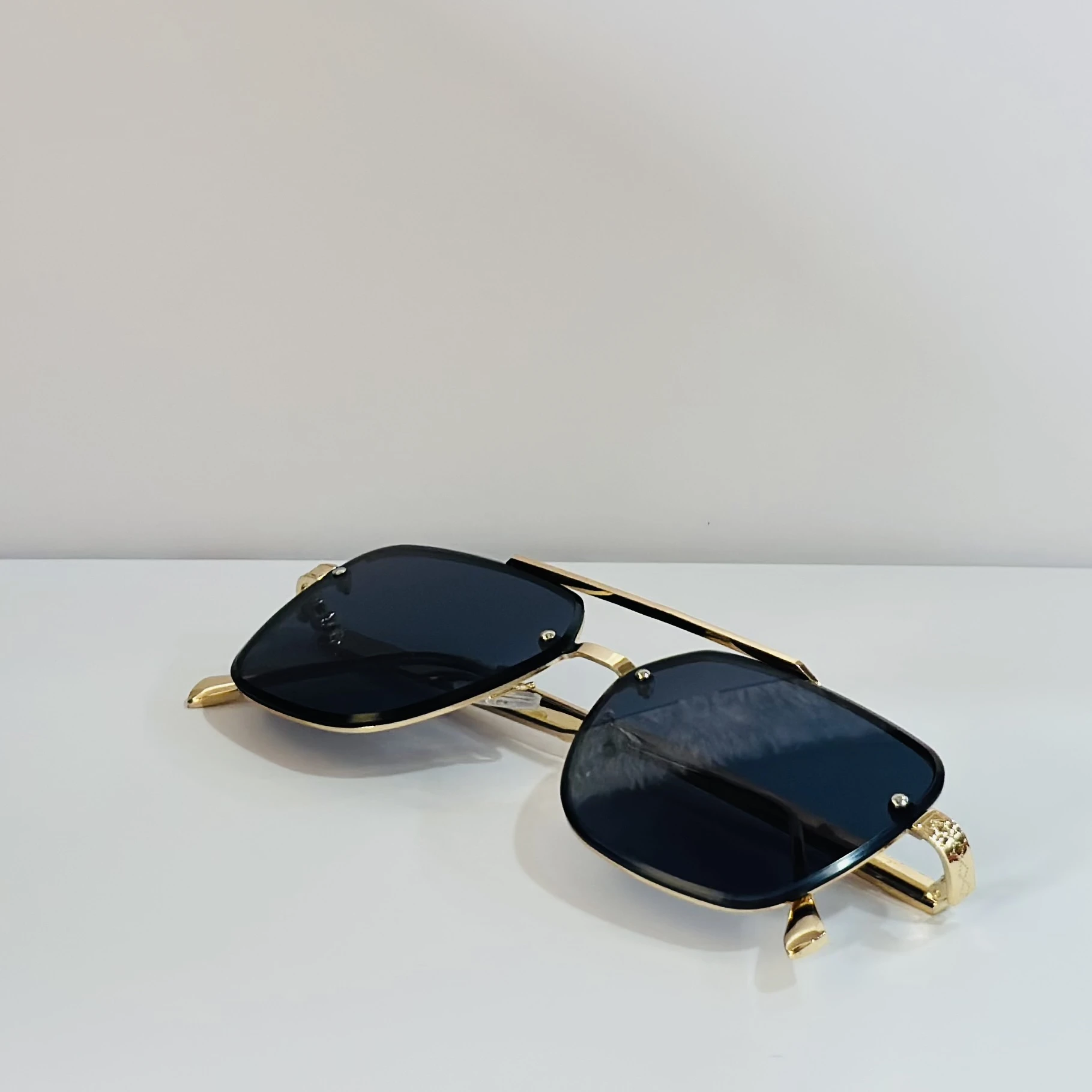 pair of Versace VE 2275 sunglasses with a gold metal frame and black/grey lenses.