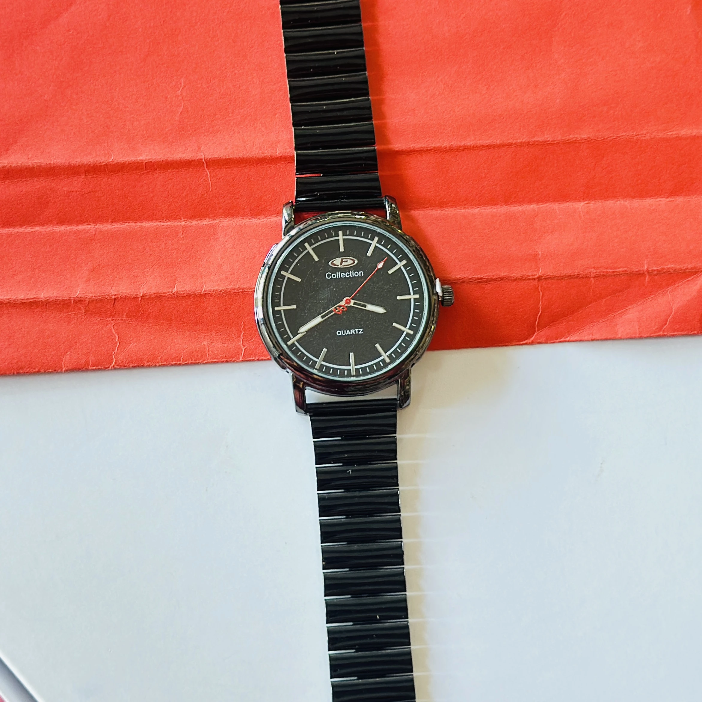 Limestone brand analog wrist watch featuring a black dial and a black band