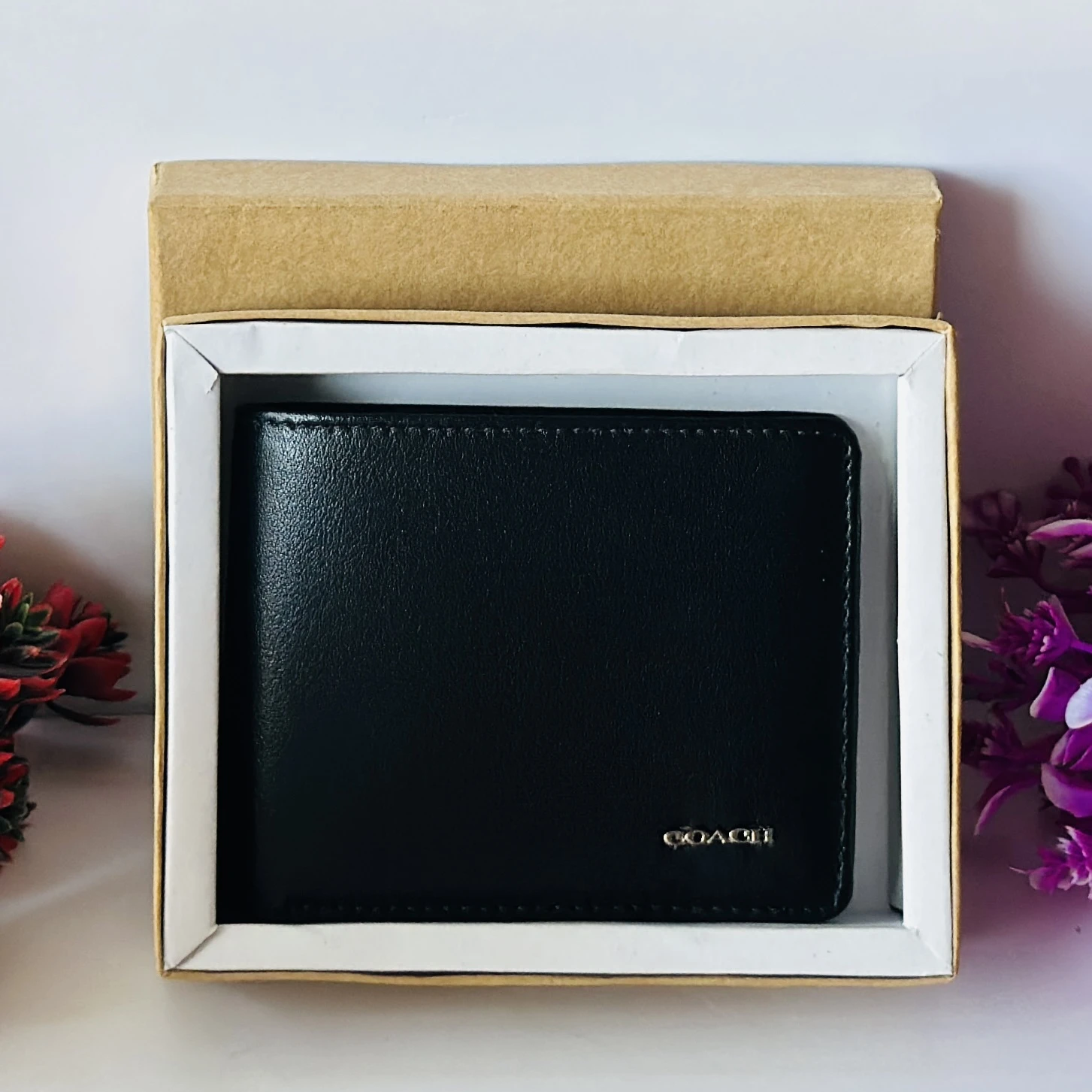 Black genuine leather bifold wallet from Coach.