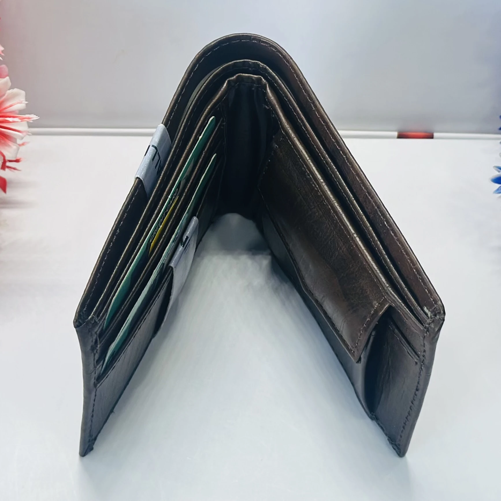 a brown bifold wallet, possibly made of genuine leather, branded as a Montblanc product.