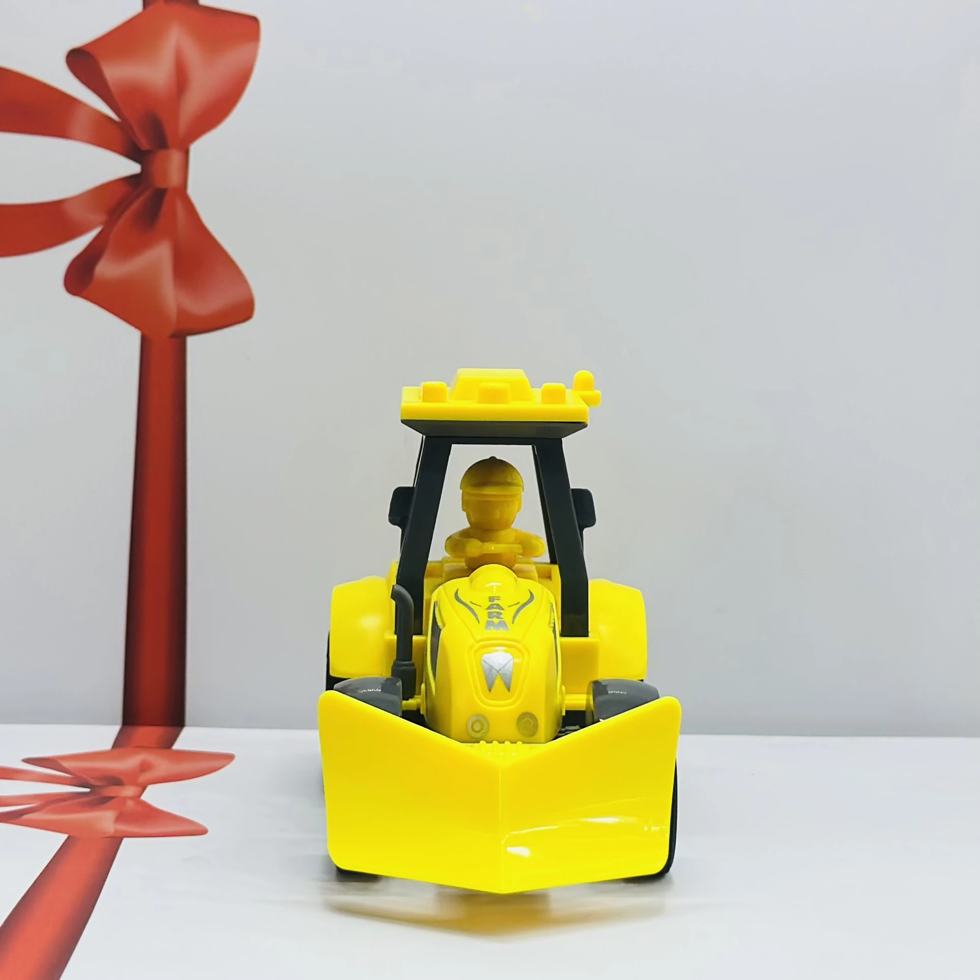 Yellow plastic toy tractor