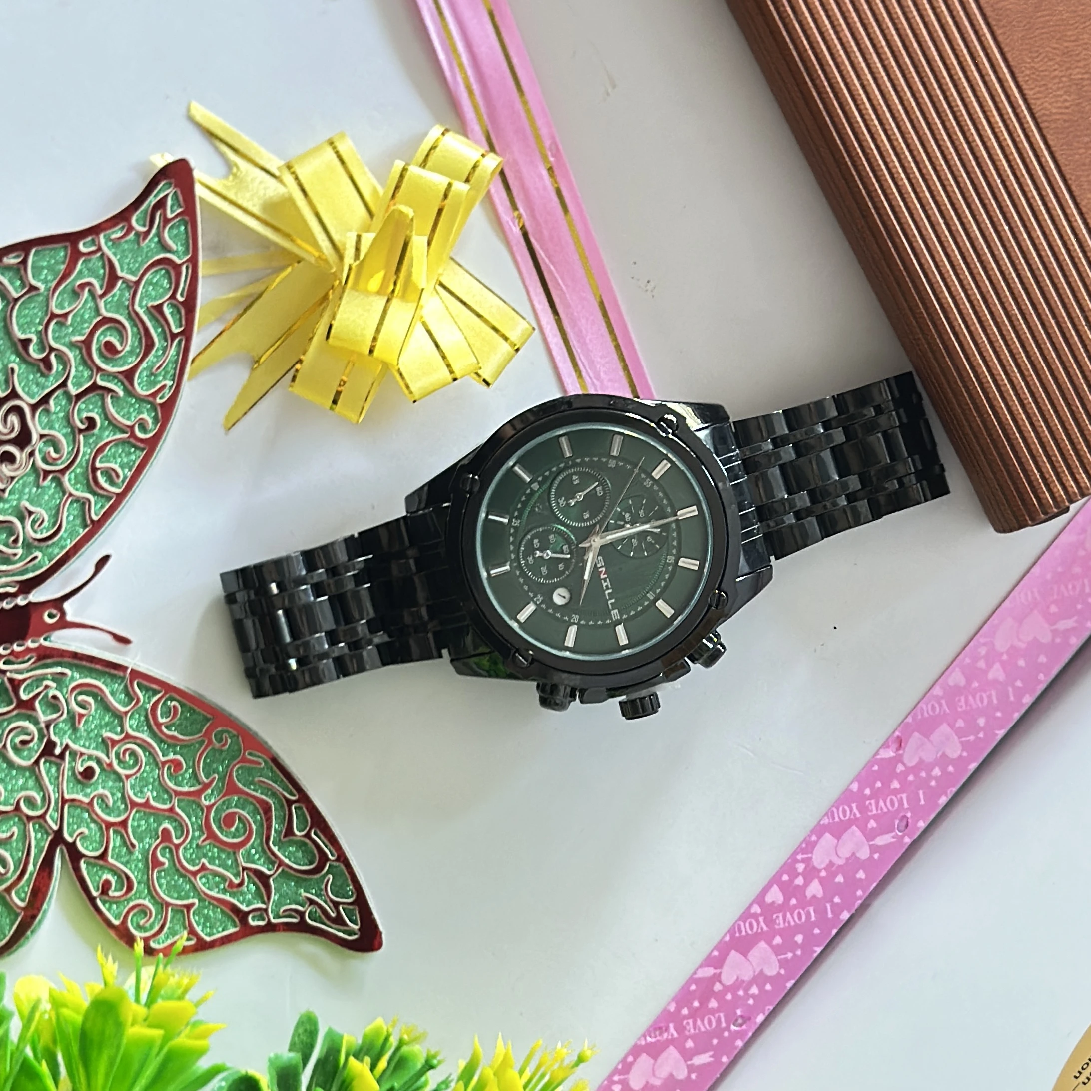 Black analog wristwatch with a metallic strap