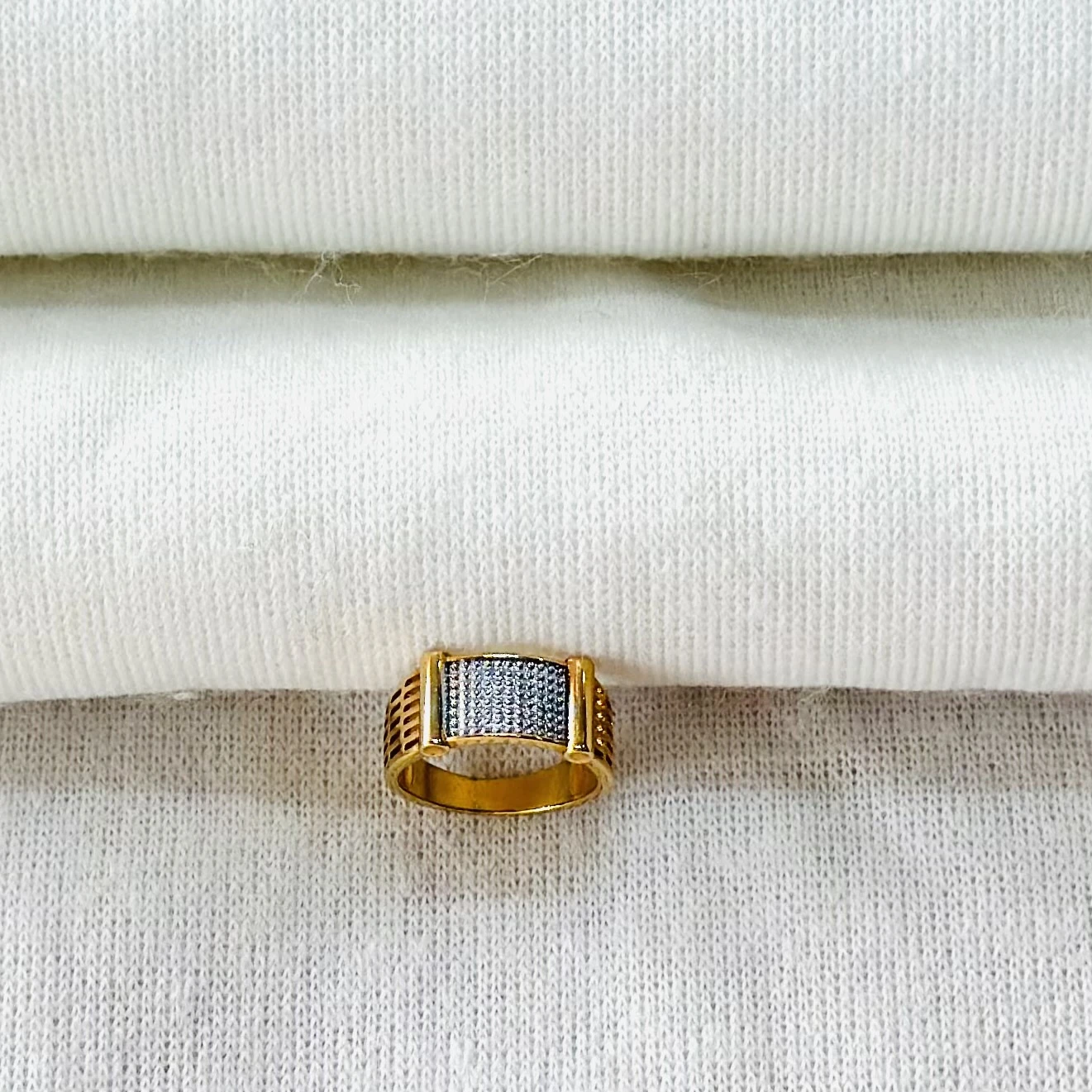 gold-toned men's ring with geometric patterns.
