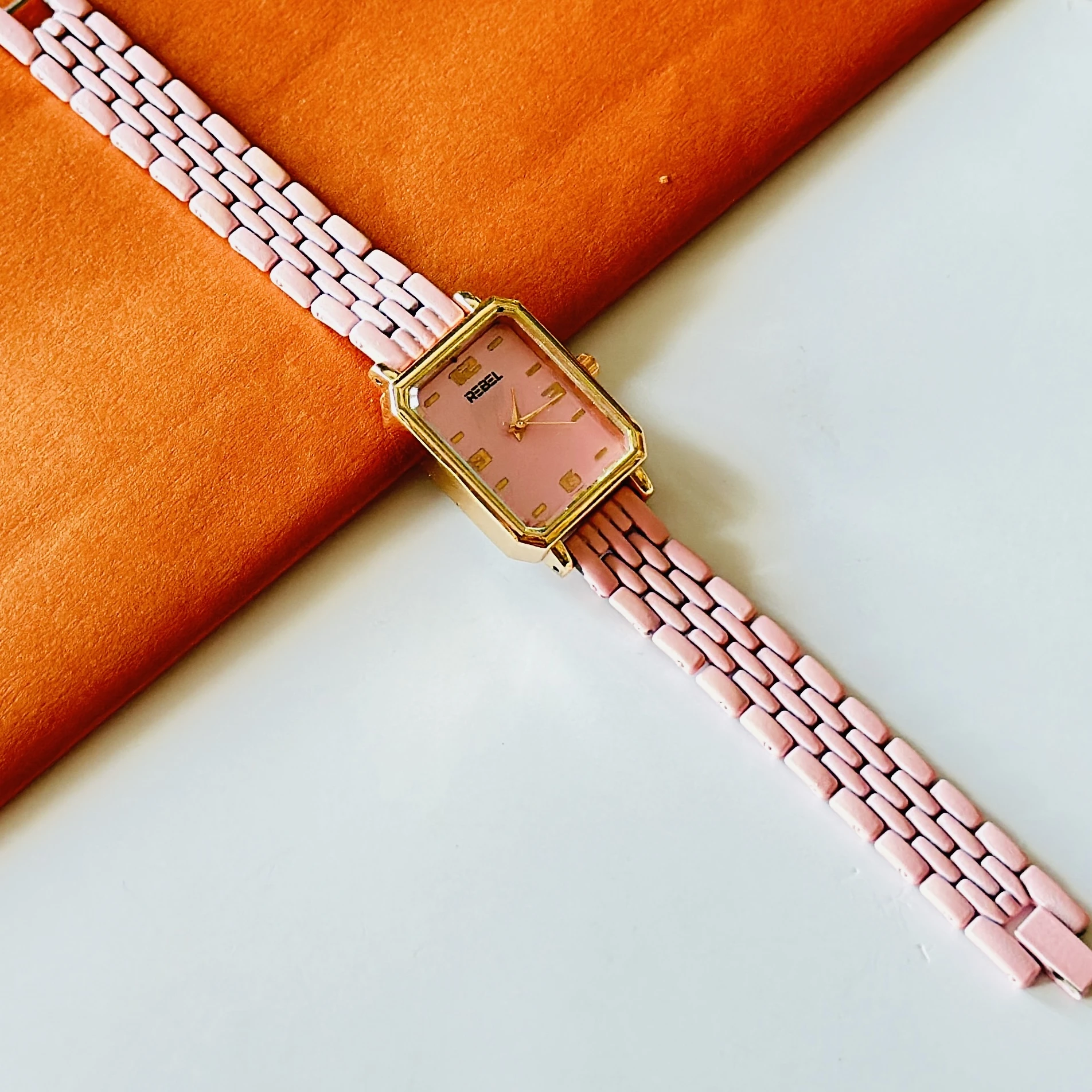 Rebel quartz watch with a pink dial and matching strap.