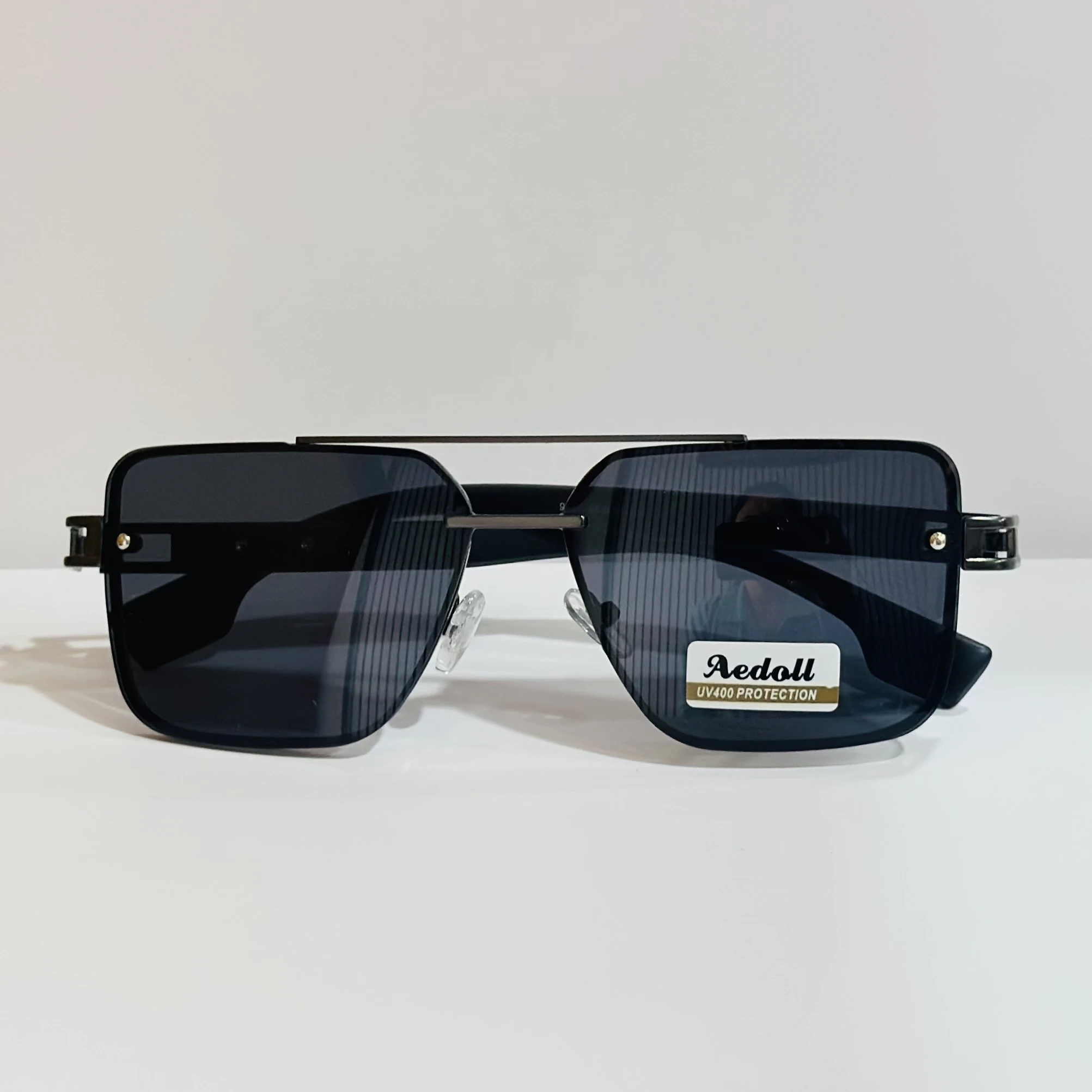 pair of square aviator sunglasses with a black metal frame and gradient lenses.