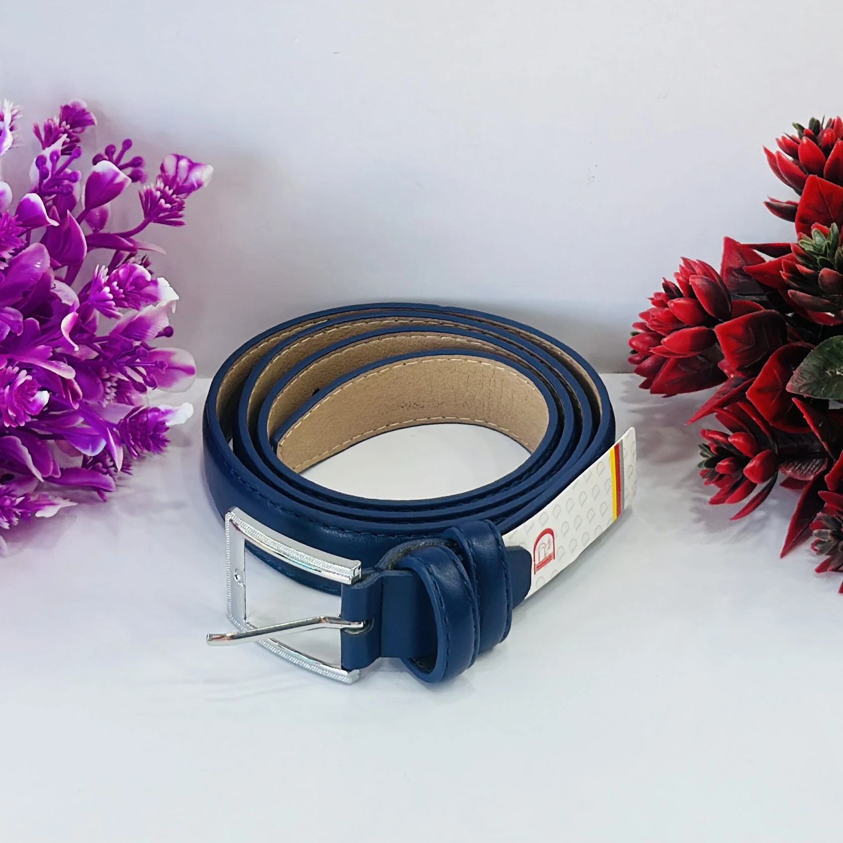 Blue leather belt with a silver-tone buckle.