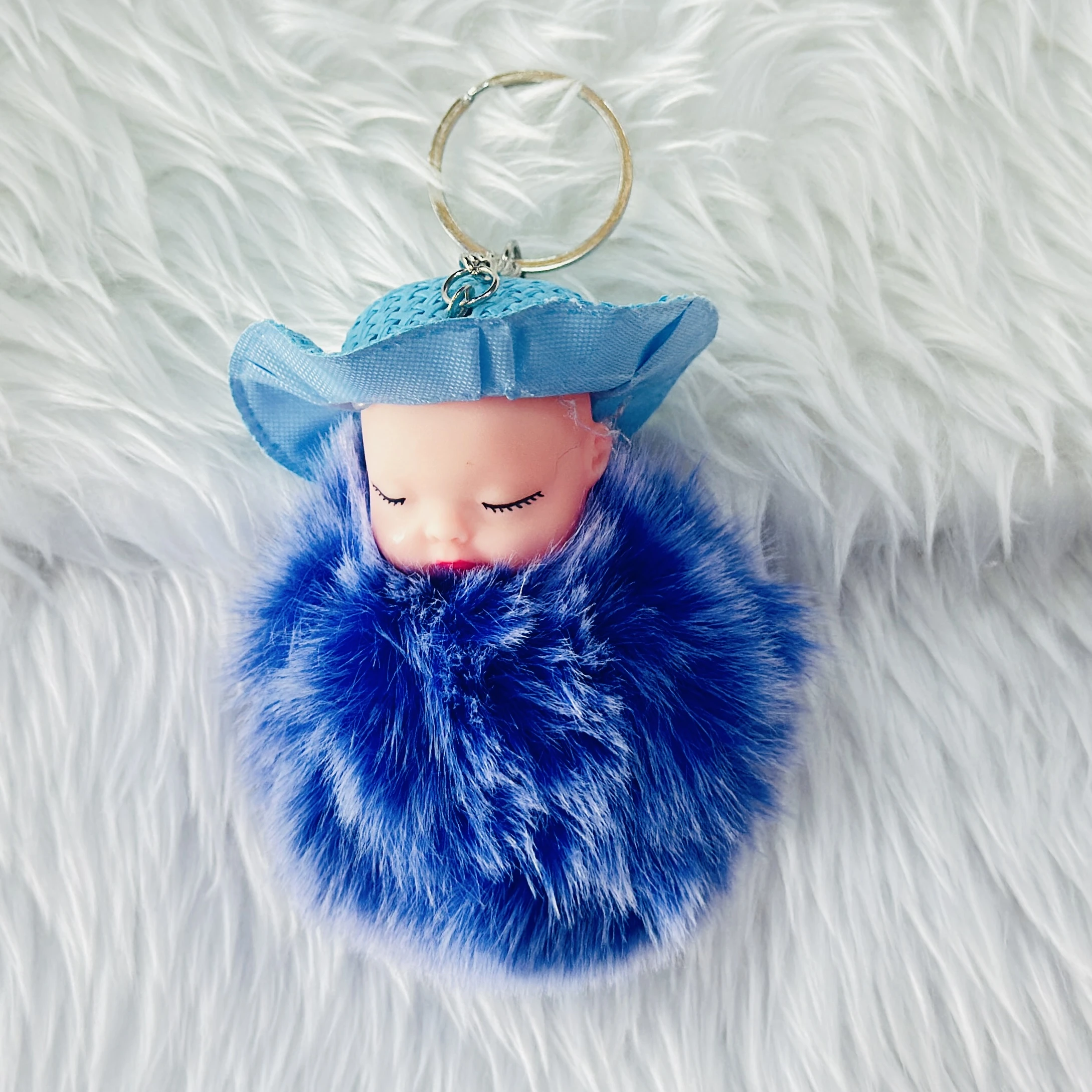 fluffy charm is a red and white SRG sleeping baby doll keychain