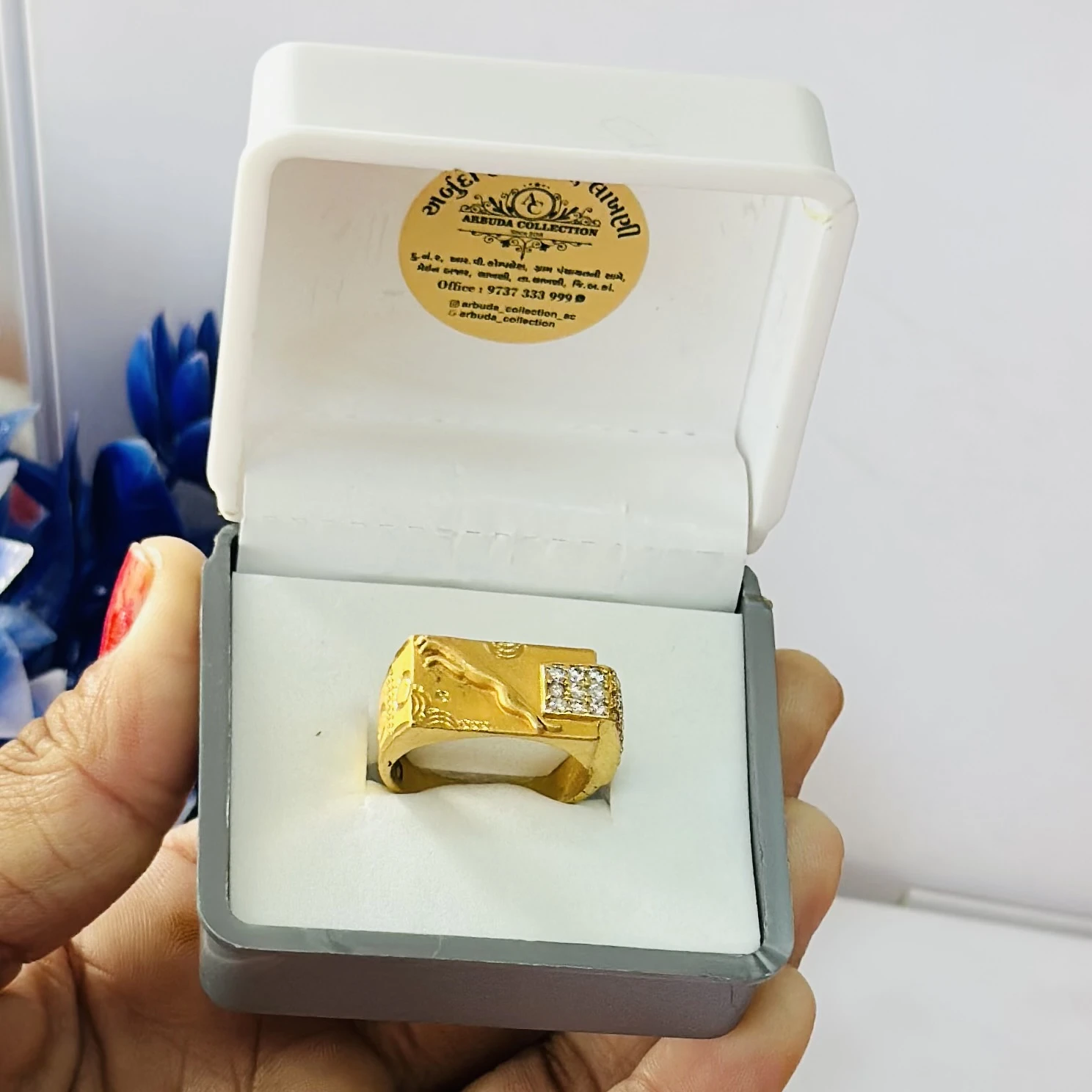 gold gent's ring with a textured design and diamond accents.