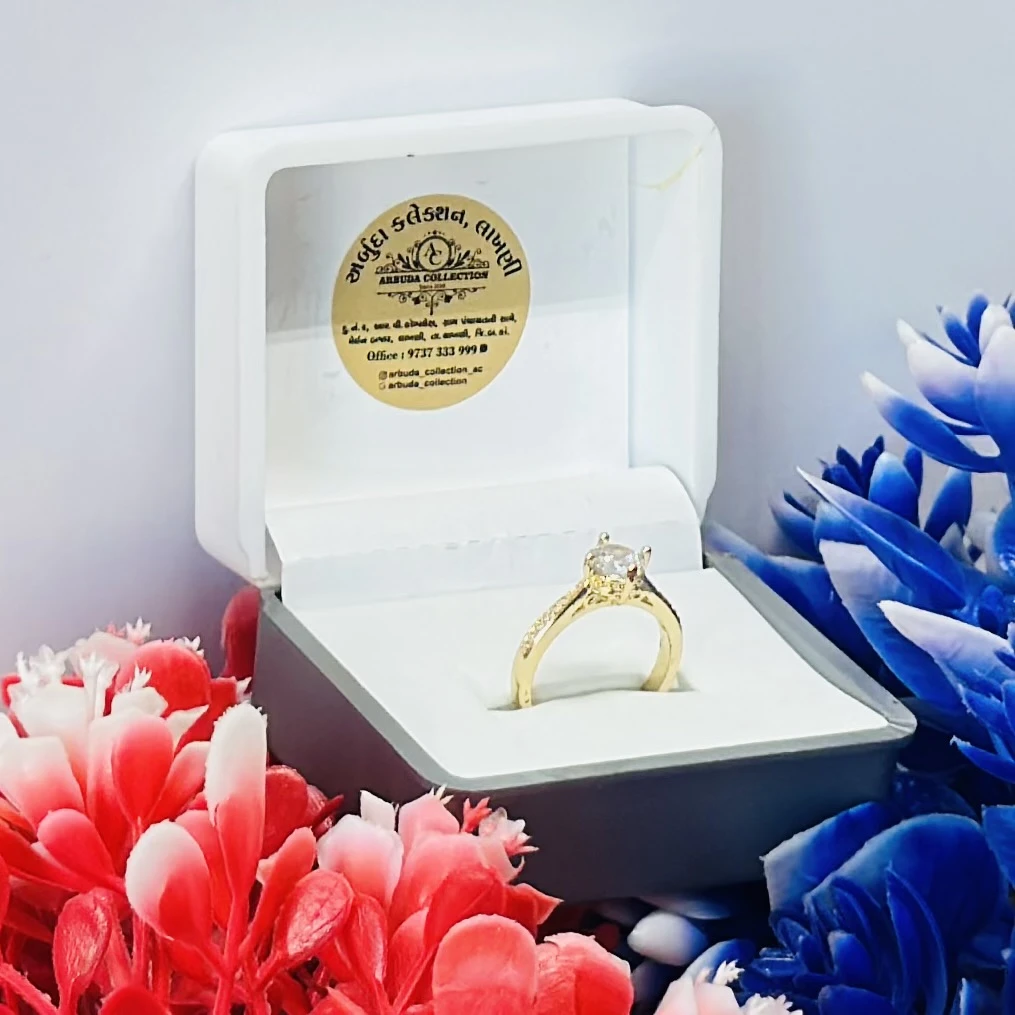 Yellow gold engagement ring with a central stone and side accents.
