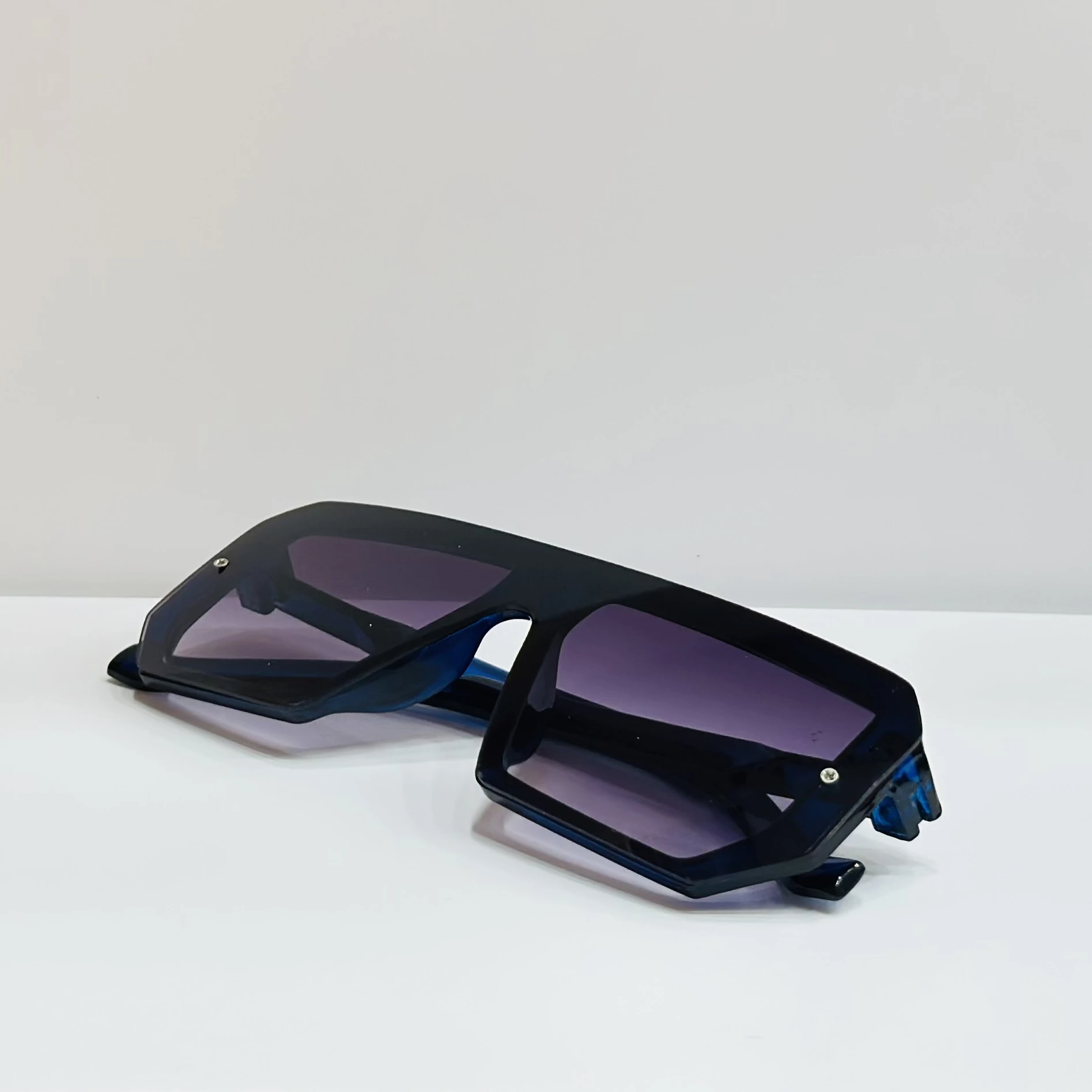 black polycarbonate oversized rectangular sunglasses.