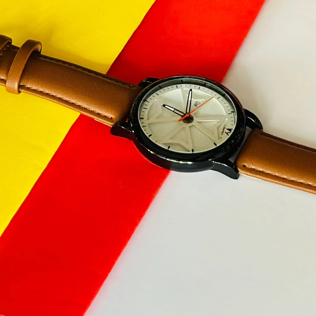 Round analog watch with a brown leather strap