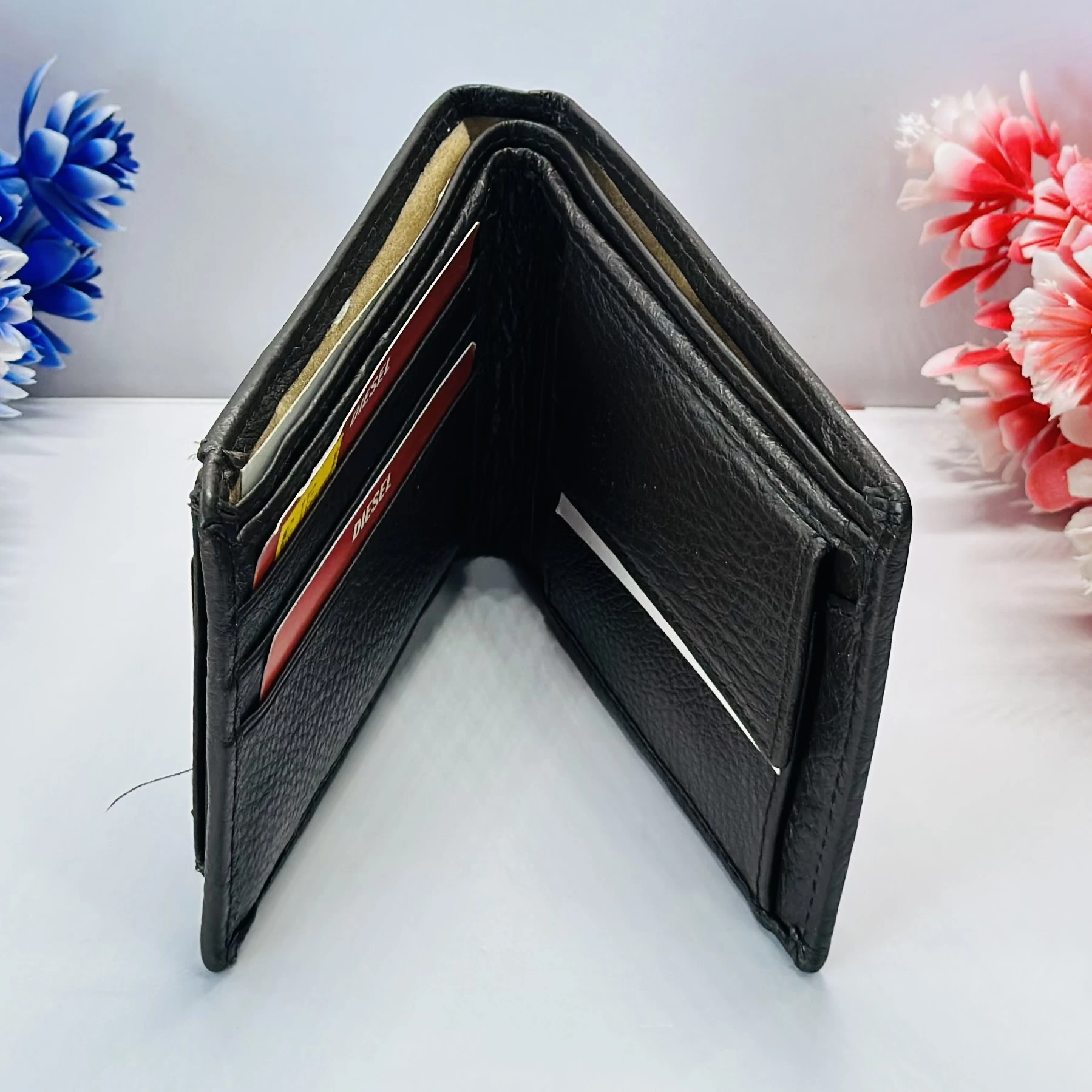 Diesel bi-fold wallet in black grainy leather.