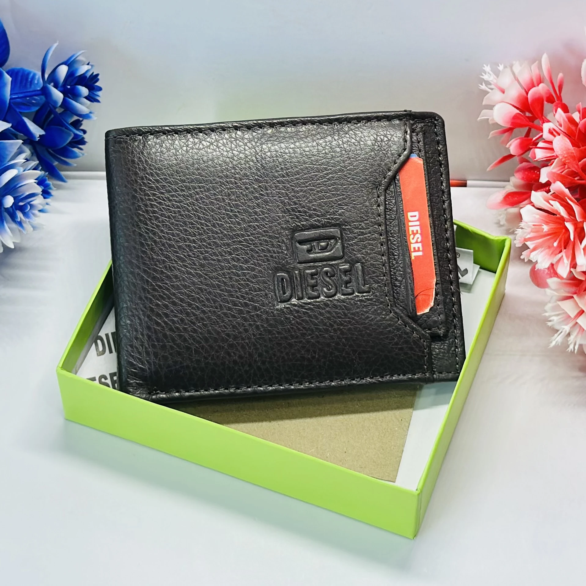 Diesel bi-fold wallet in black grainy leather.