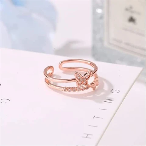 Rose gold plated cubic zirconia butterfly double band ring.