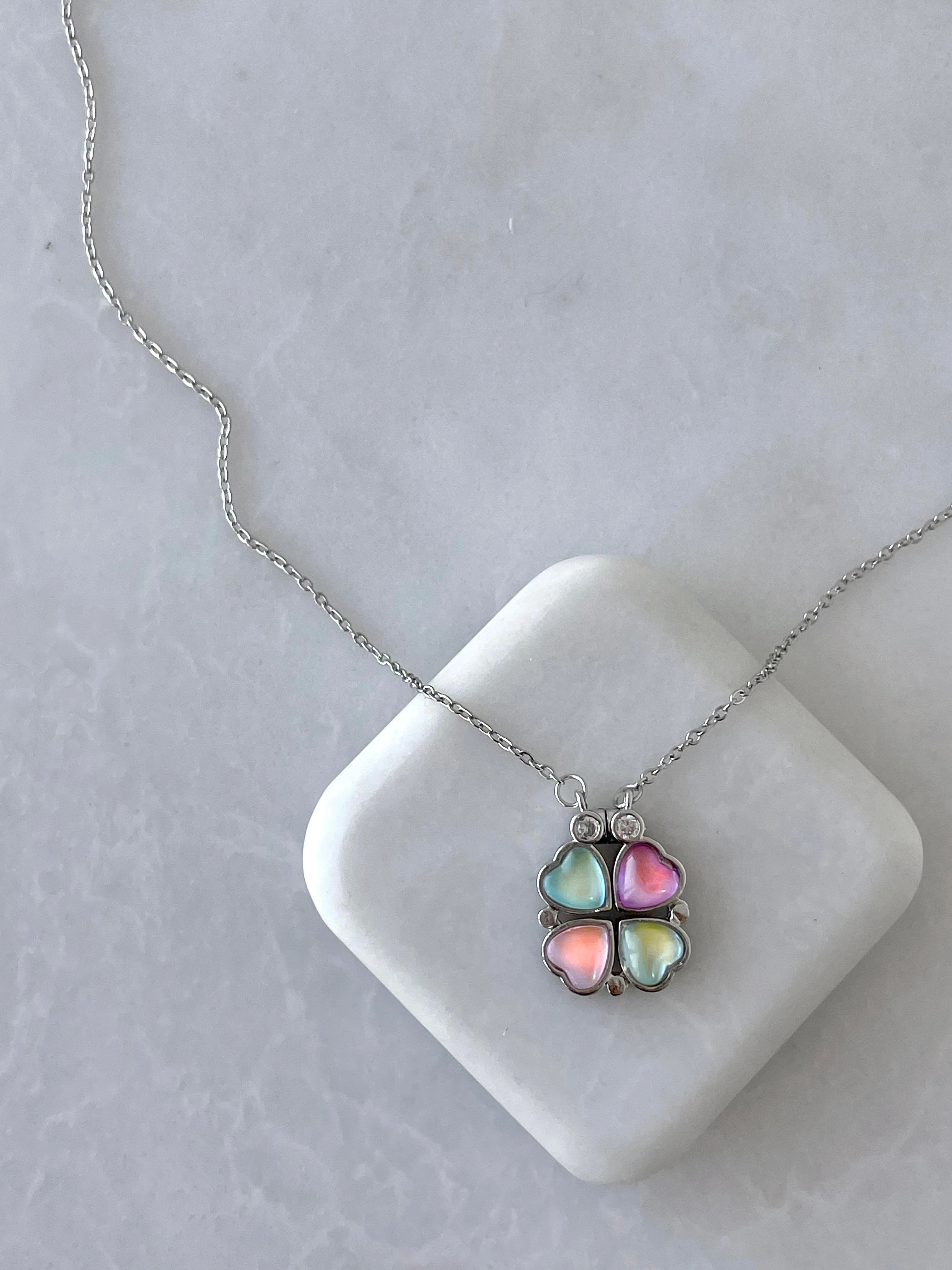 stainless steel clover necklace features magnetic hearts that can change shape