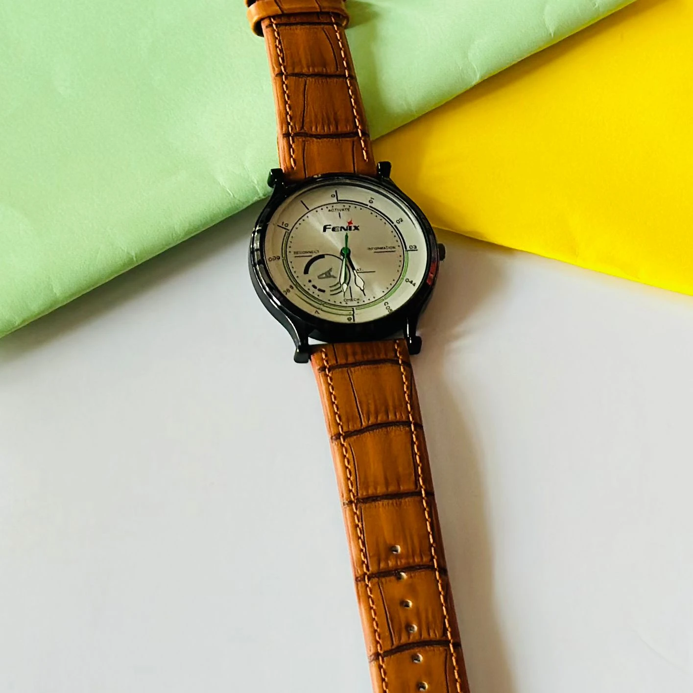 Round  analog watch with a brown leather strap