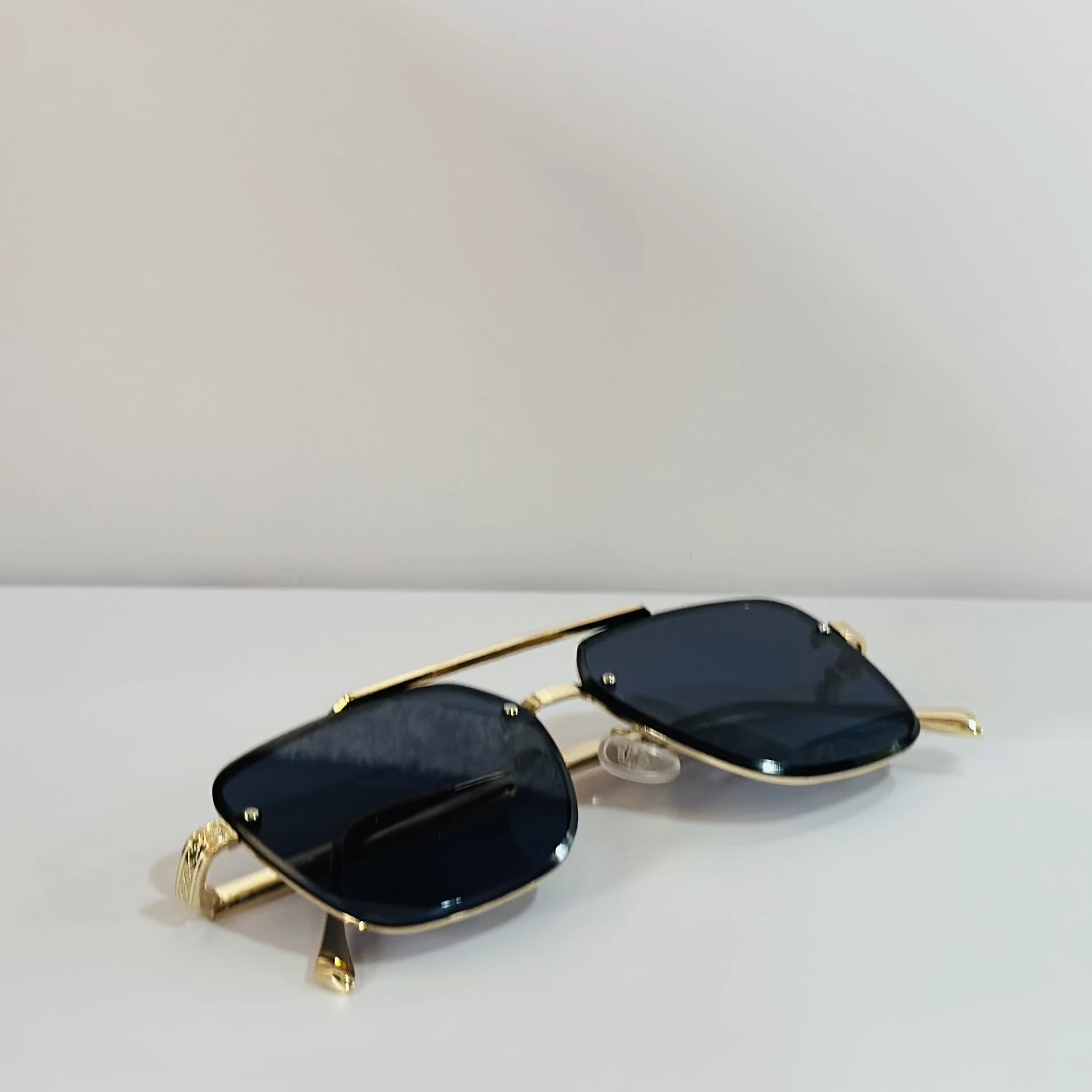 pair of Versace VE 2275 sunglasses with a gold metal frame and black/grey lenses.