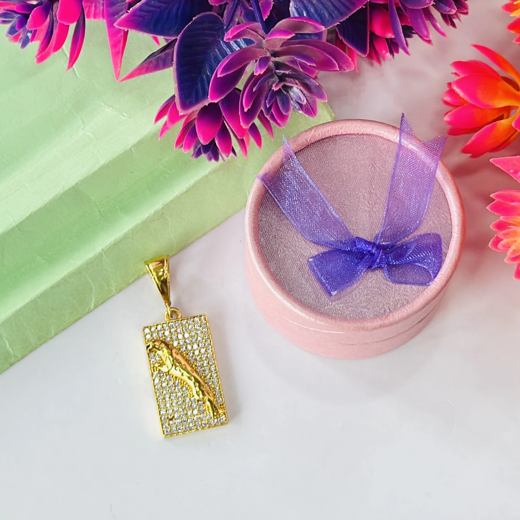 Gold plated jaguar pendant with a diamond texture background.
