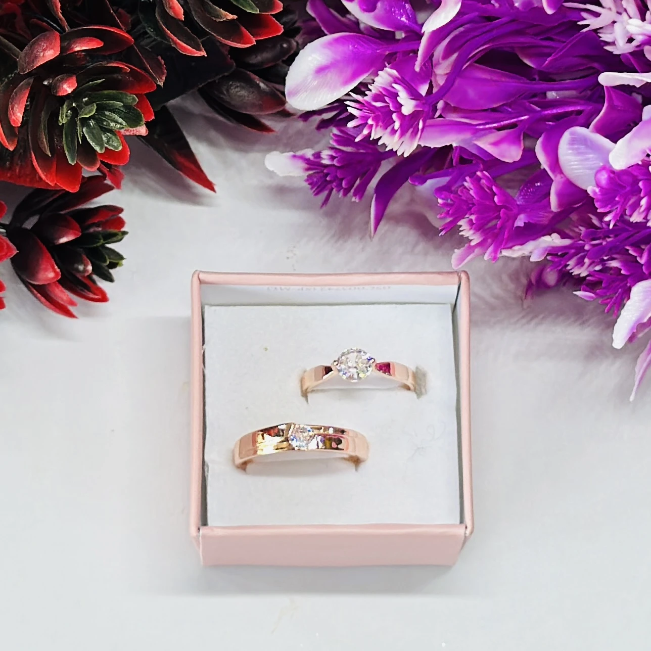 Rose gold-plated cubic zirconia couple rings.
