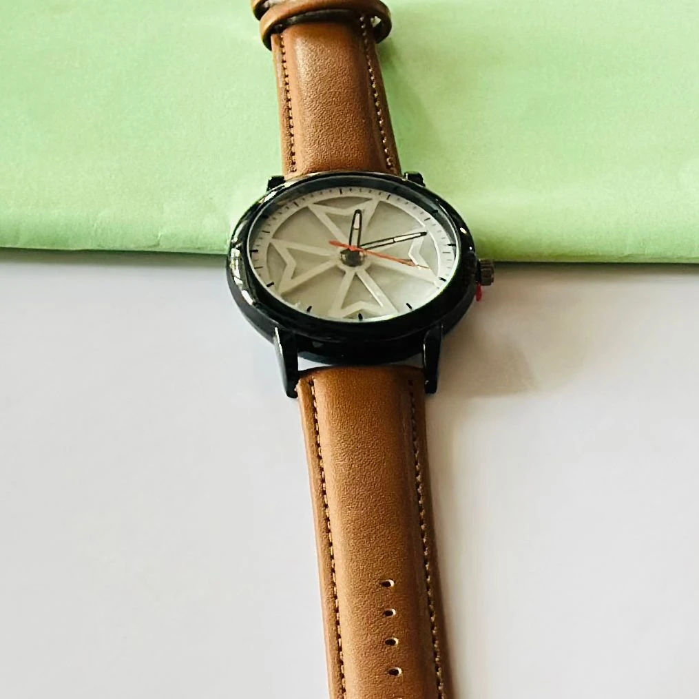 Round analog watch with a brown leather strap