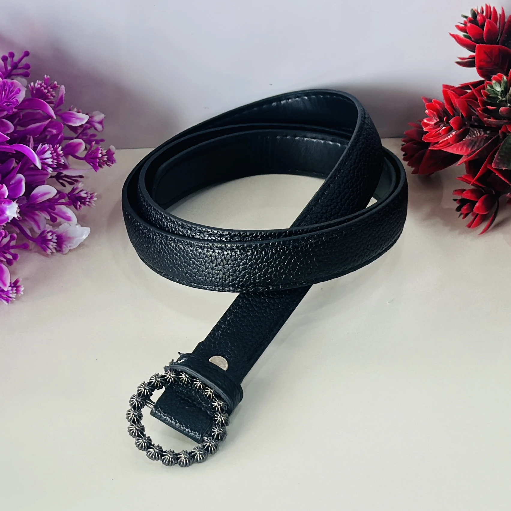 Black PU leather belt with an embellished metal buckle.