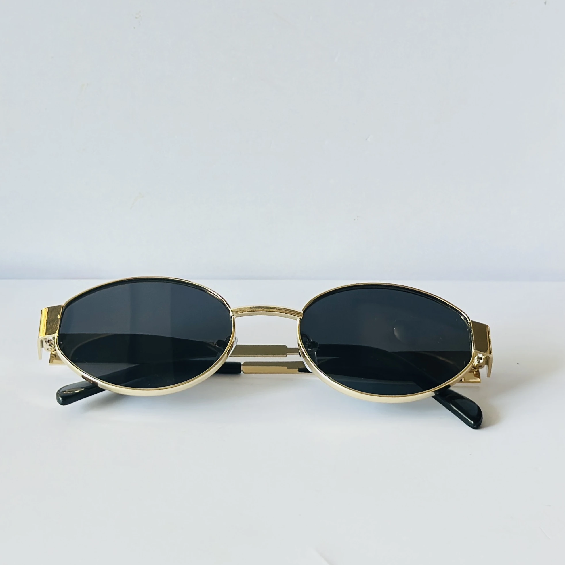 classic gold-framed oval sunglasses