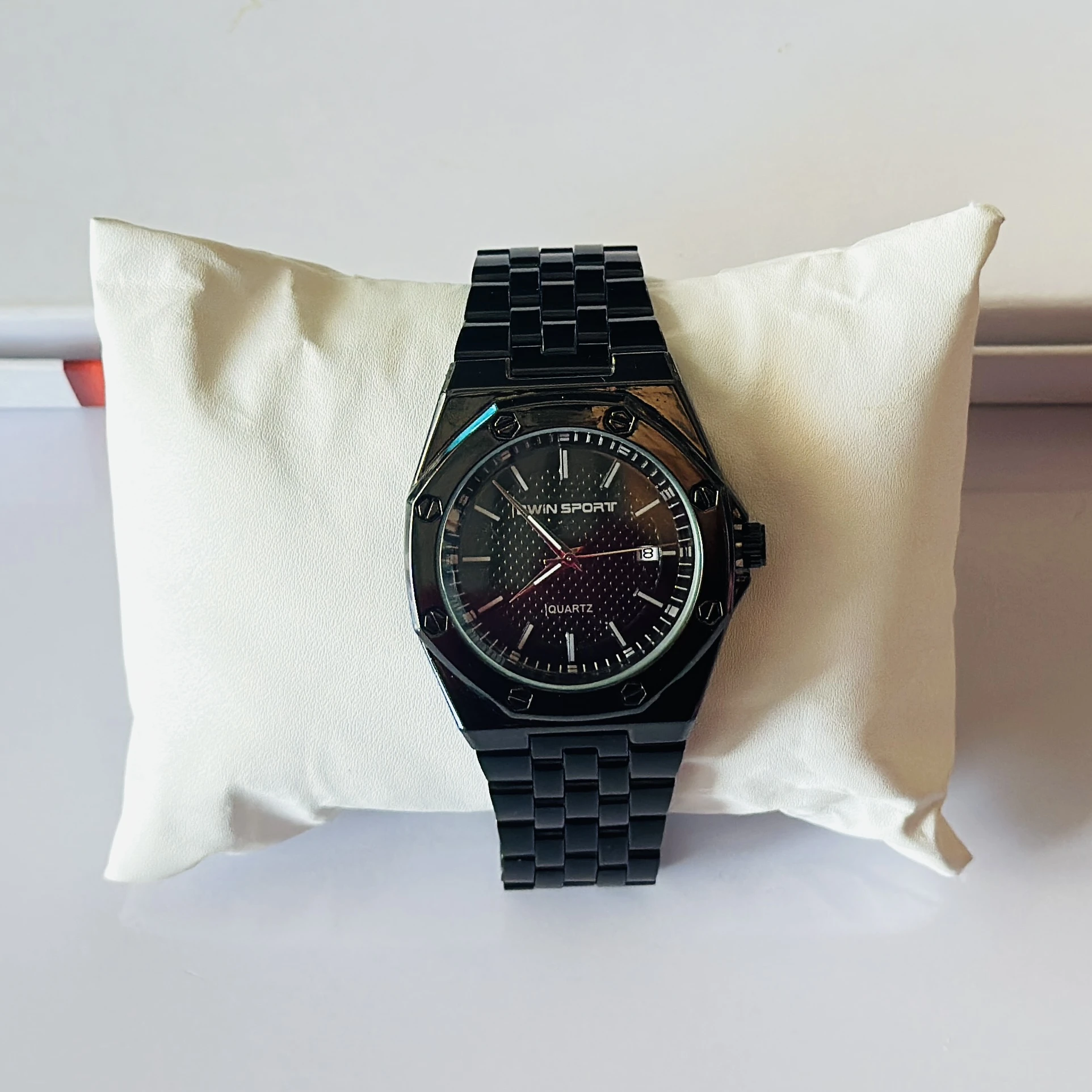 appears to be a black metal analog quartz watch