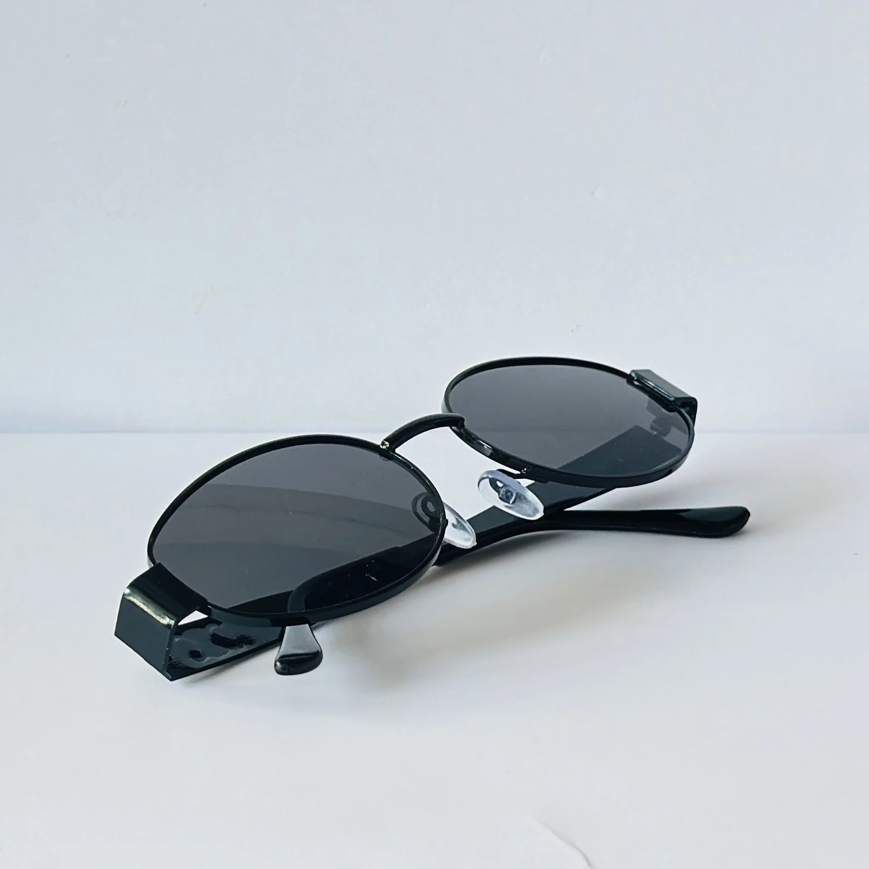 Black sunglasses feature a metal frame and black lenses