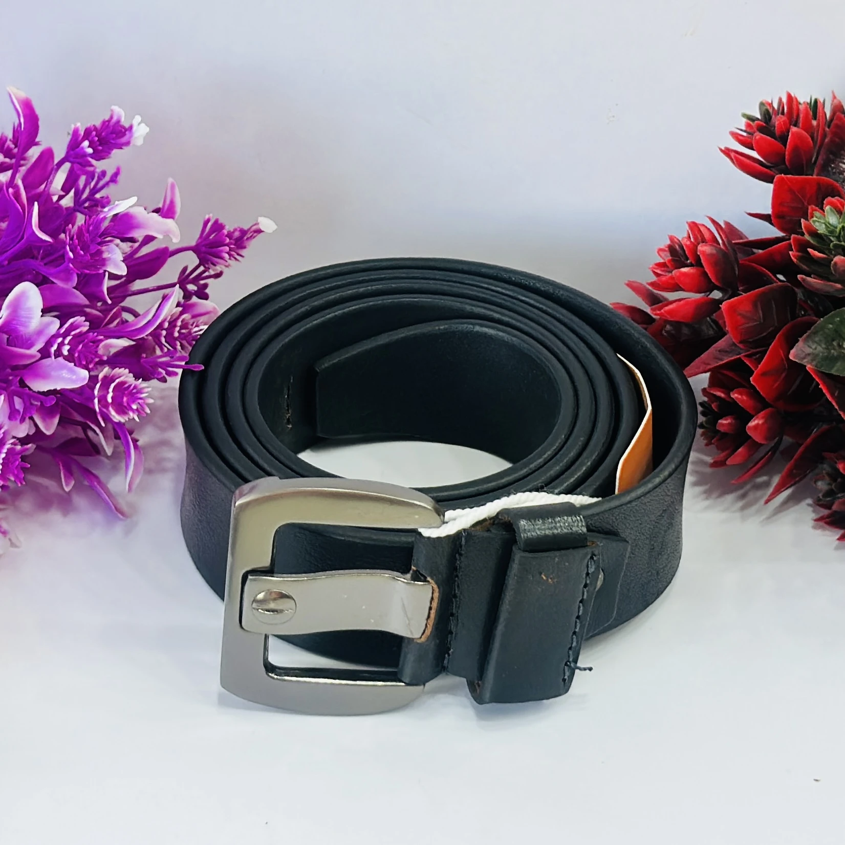 Black leather belt with a silver-tone buckle.