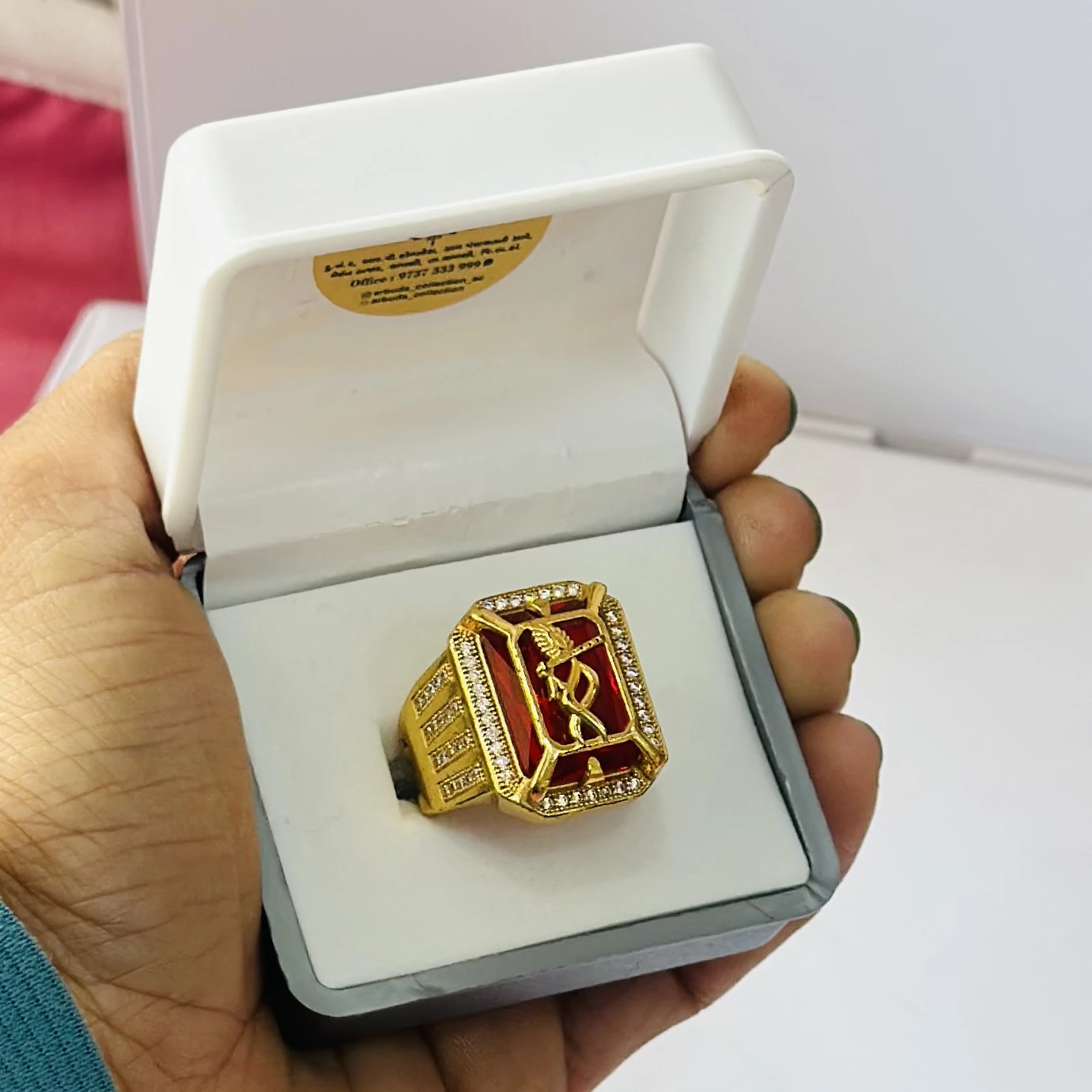 1 gram gold-plated Mudra ring with a red stone centerpiece.