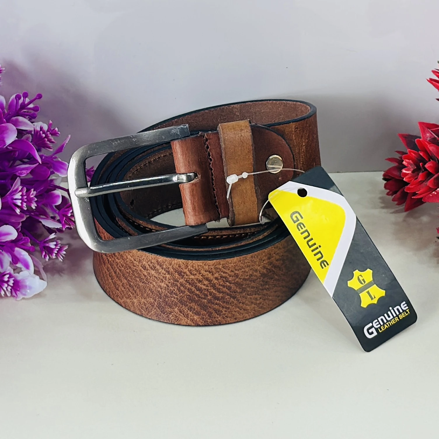 brown genuine leather belt with a pin buckle closure.