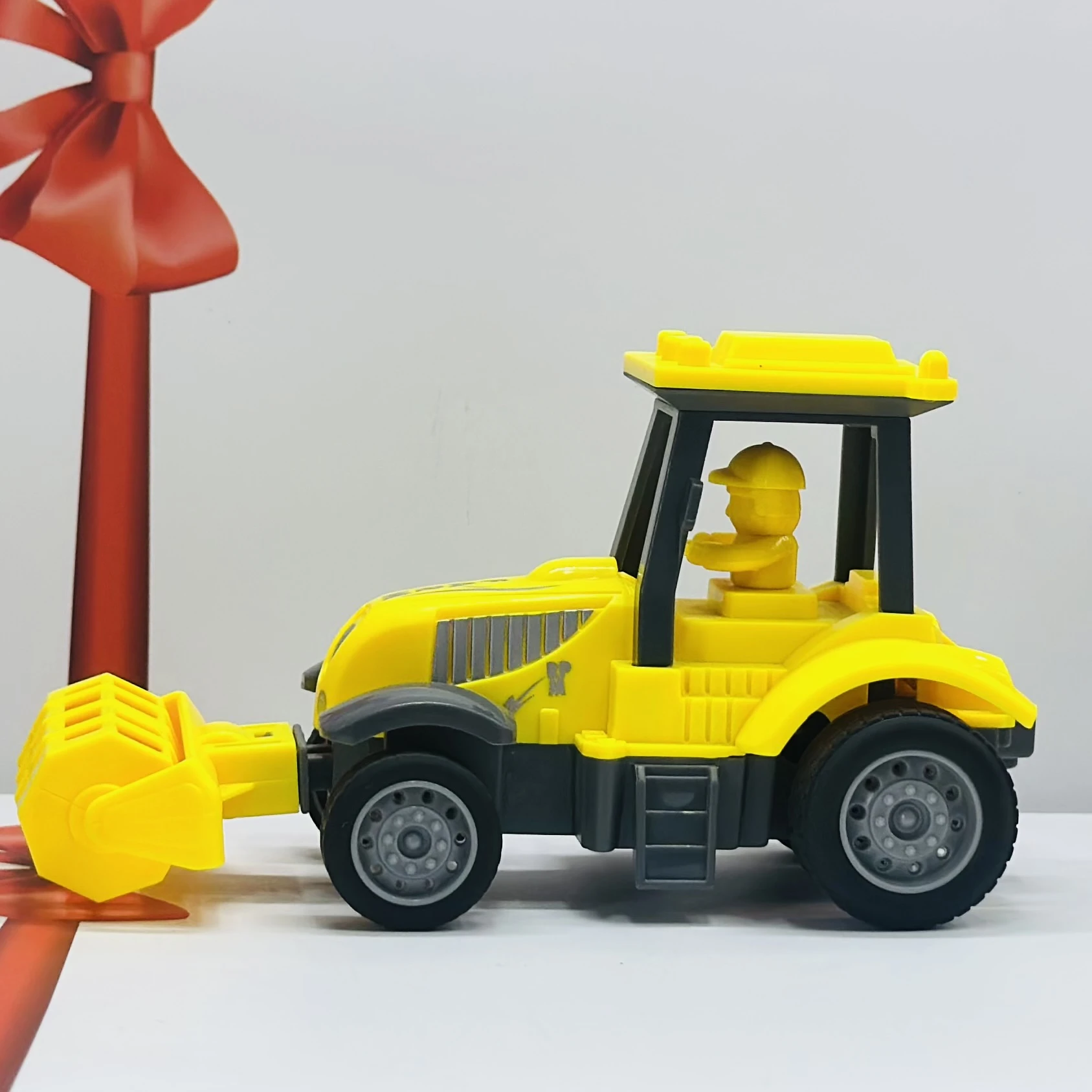 Yellow plastic toy tractor