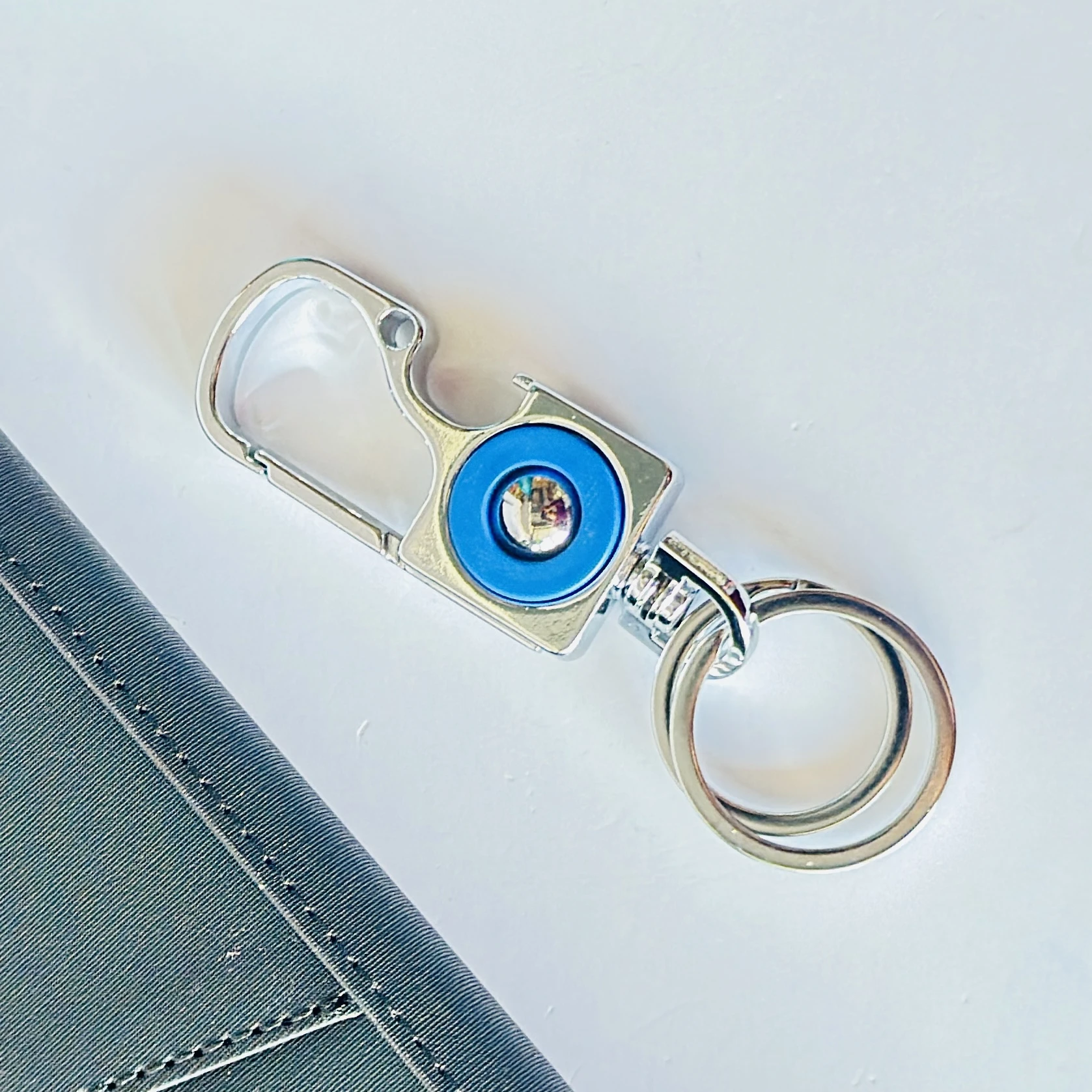 silver and blue metal accessory is an Omuda carabiner keychain