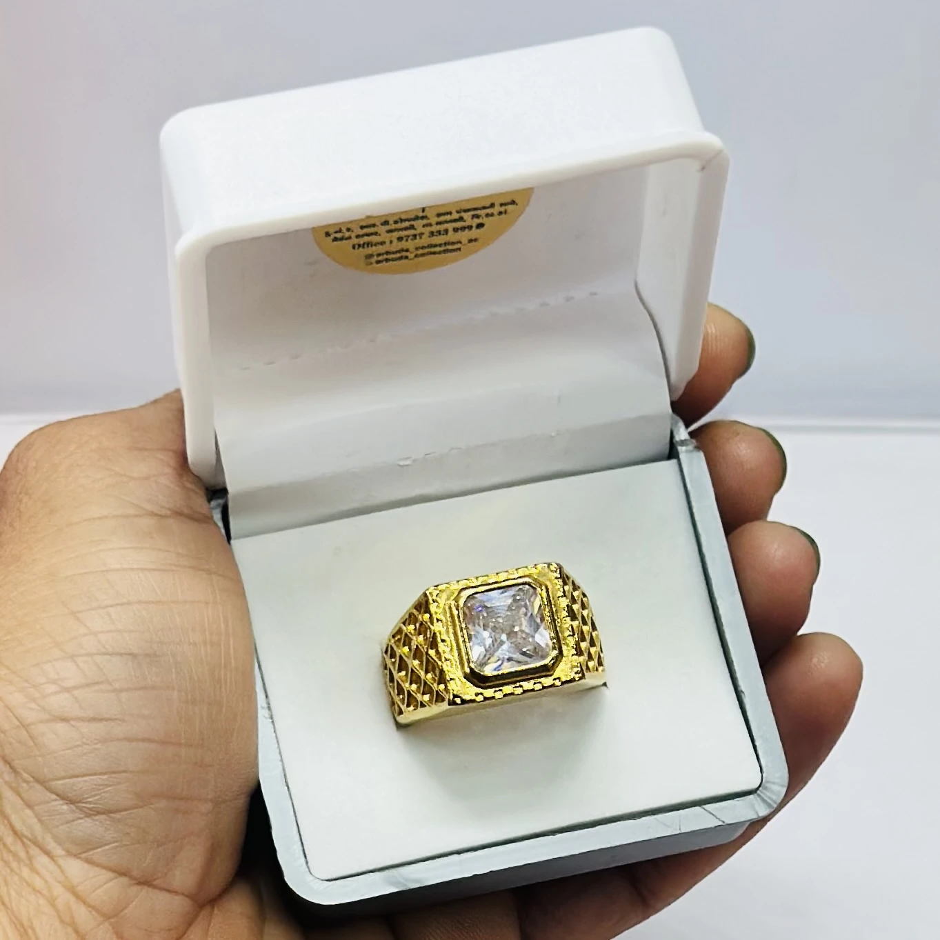 Gold plated men's ring with a square-cut cubic zirconia stone.