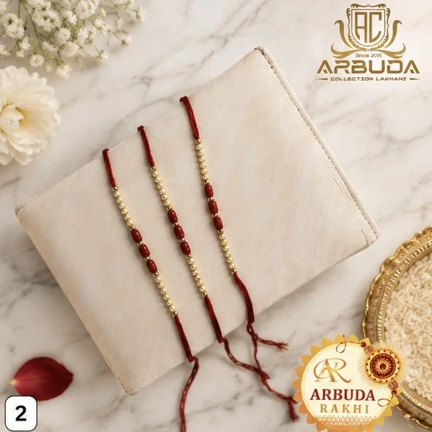 red thread rakhis adorned with alternating red and gold-colored beads.