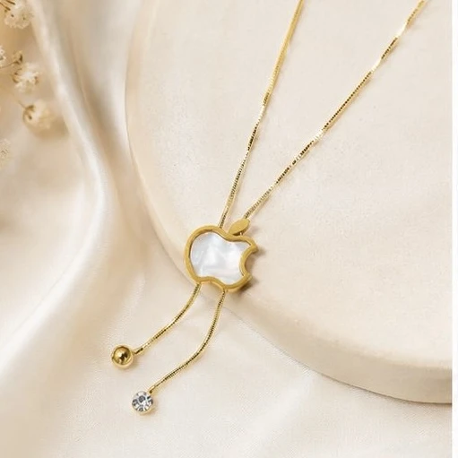 gold-toned necklace features a distinct apple-shaped pendant filled with white mother-of-pearl.